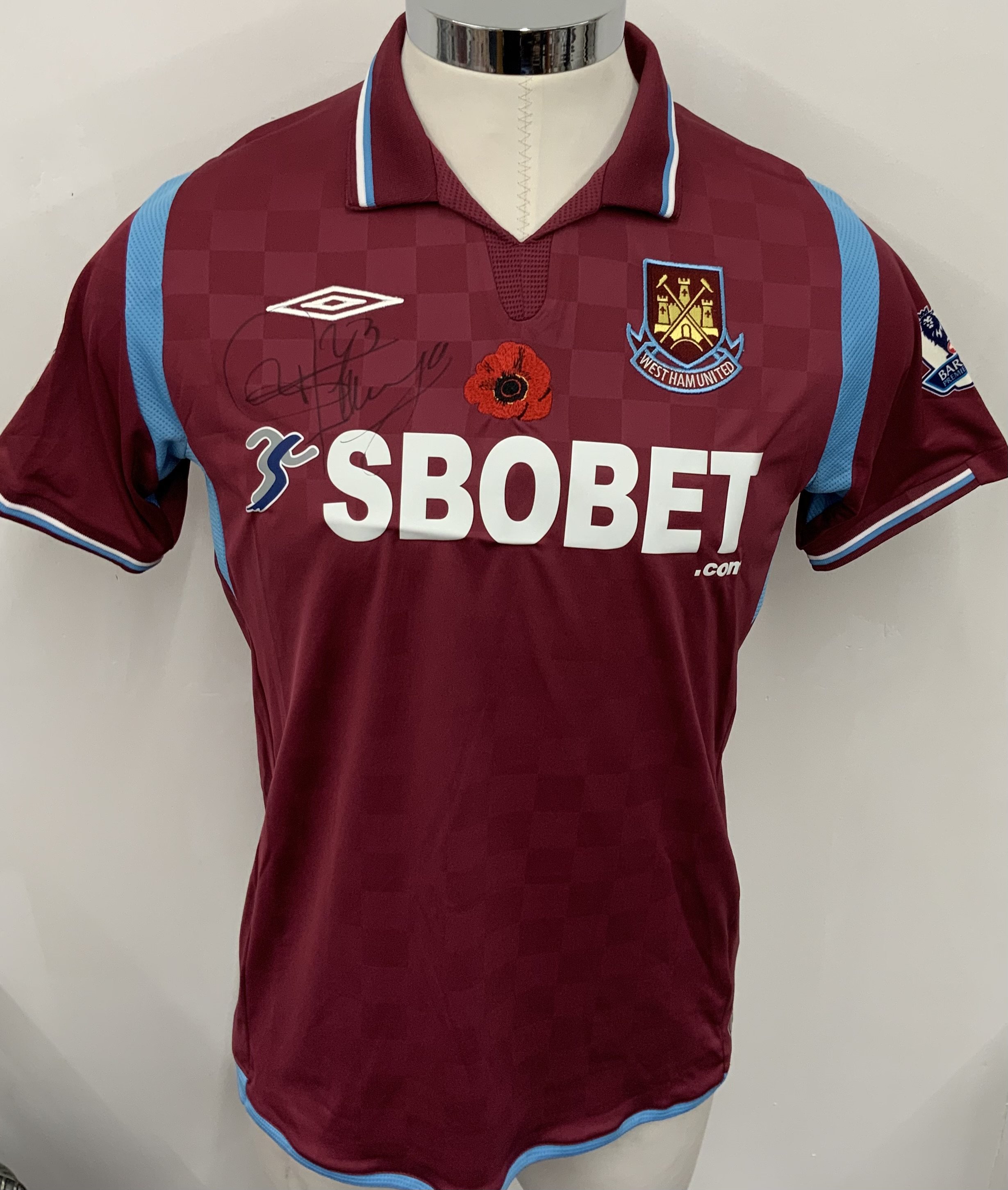 West Ham 2009 - 2010 Match Prepared Football Shirt: Claret and blue short sleeve poppy shirt with Premier League badging to sleeves. Ilunga 23 to rear. Signed to front and rear by the player. Prepared for the match v Everton on 8 November 2009.
