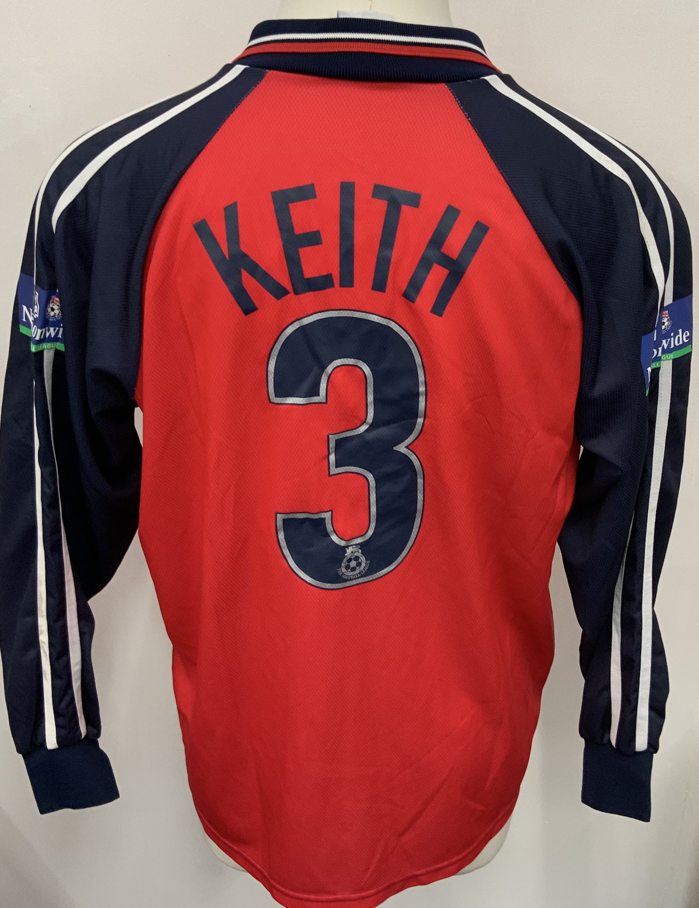 Colchester United 2001 - 2002 Match Worn Football Shirt: Red long sleeve third shirt with Nationwide League badging to sleeves. Keith 3 to rear. Signed to front by the player. 