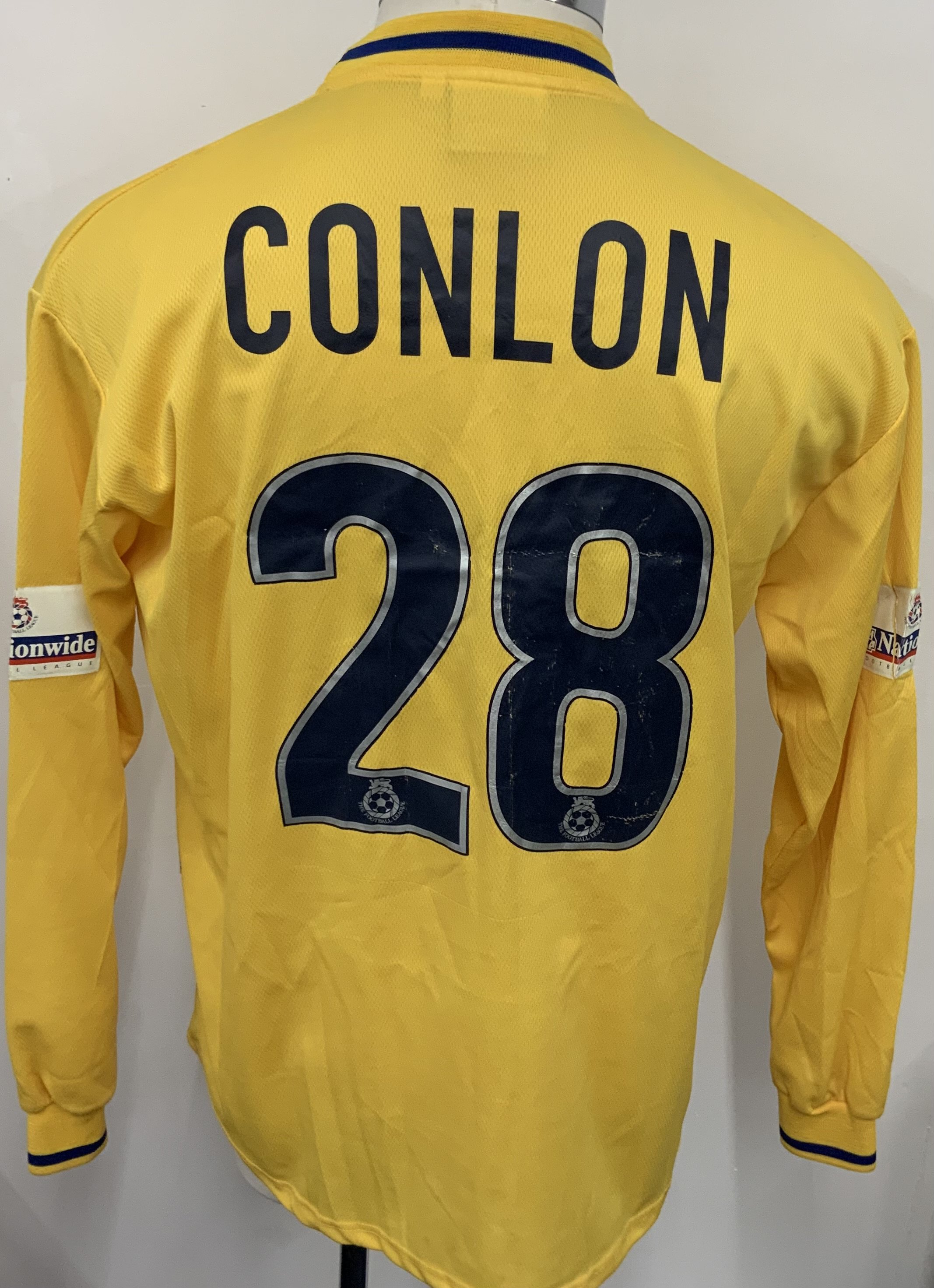 Colchester United 2000 - 2001 Match Worn Football Shirt: Yellow long sleeve shirt with Nationwide League badging to sleeves. Conlon 28 to rear. Signed to front by the squad. 