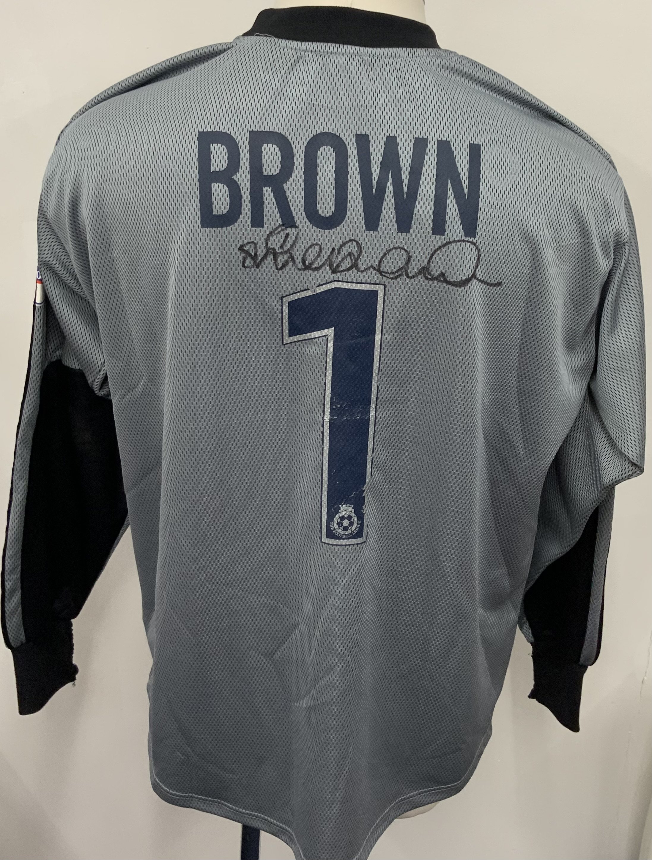 Colchester United 2003 - 2004 Match Worn Football Shirt: Grey long sleeve goalkeepers shirt with Nationwide badging to sleeves. Brown 1 to rear. Signed by player above number. Some wear to the number and sleeve badging. 

