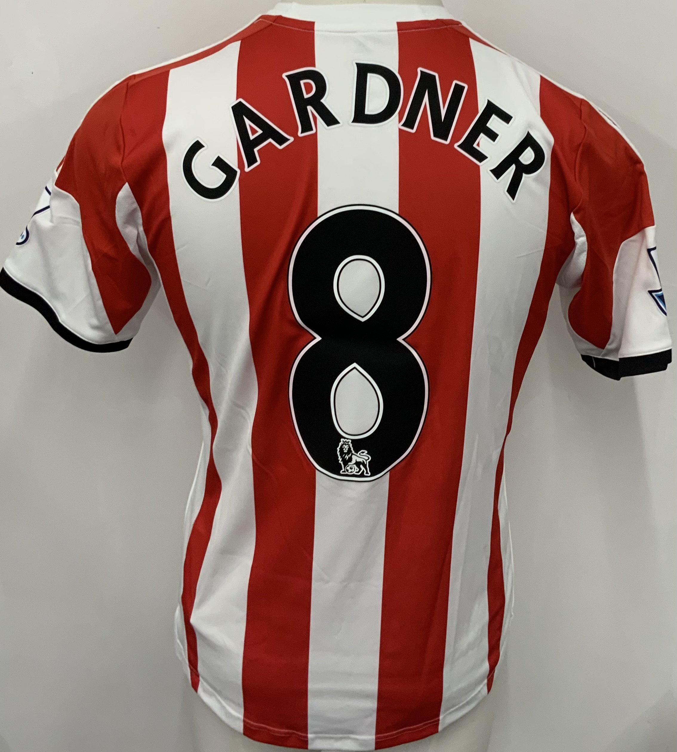 Sunderland 2013 - 2014 Match Worn Football Shirt: Red and white short sleeve  shirt with Premier League badging to sleeves. Gardner 8 to rear. Worn v Arsenal on 22 September 2013. 