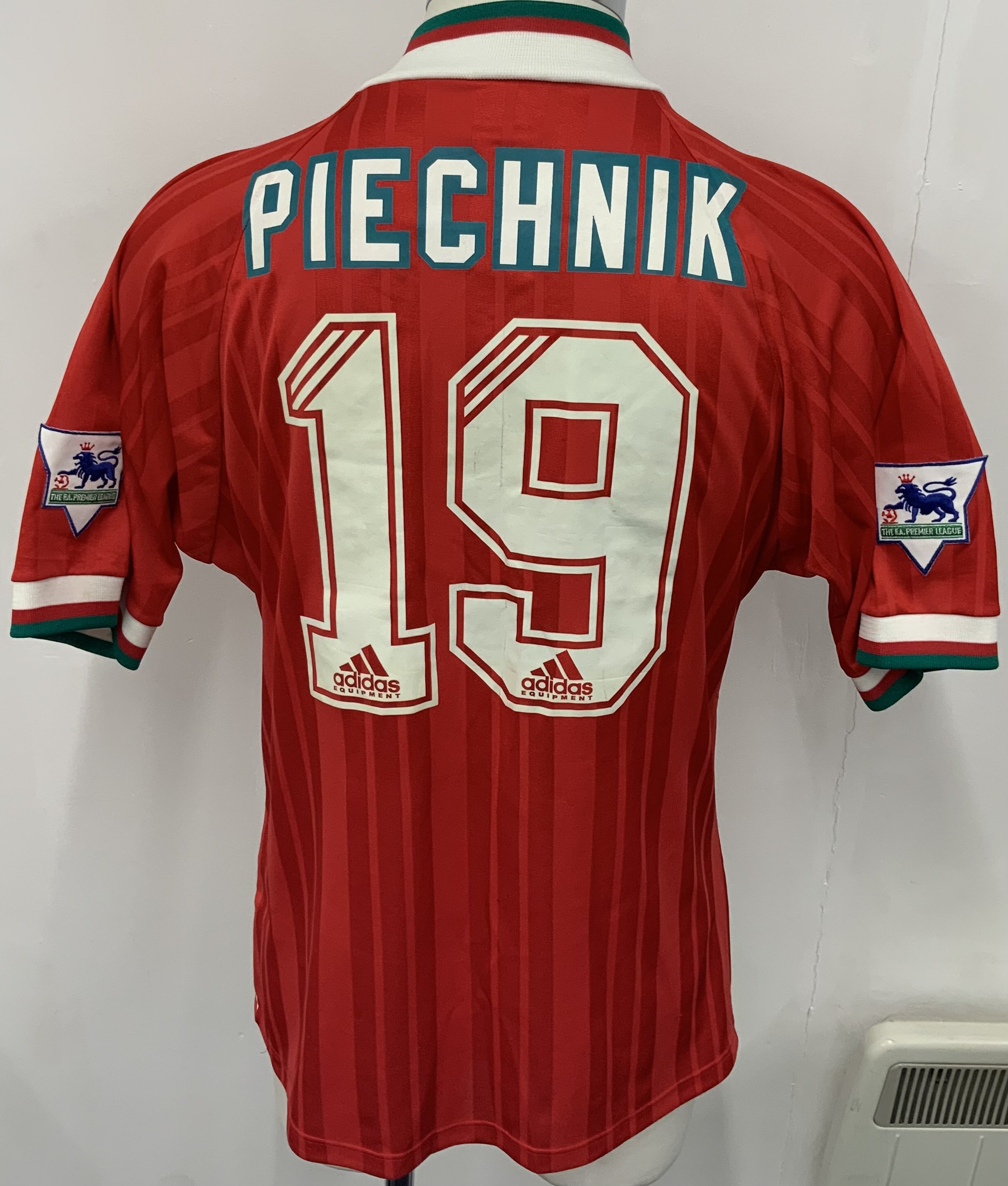Liverpool 1993 - 1994 Match Issued Signed Football Shirt: Red Carlsberg Adidas short sleeve shirt with green and white trim. Number 19 Piechnik to rear. Signed by 23 team mates to front of the Denmark International. 