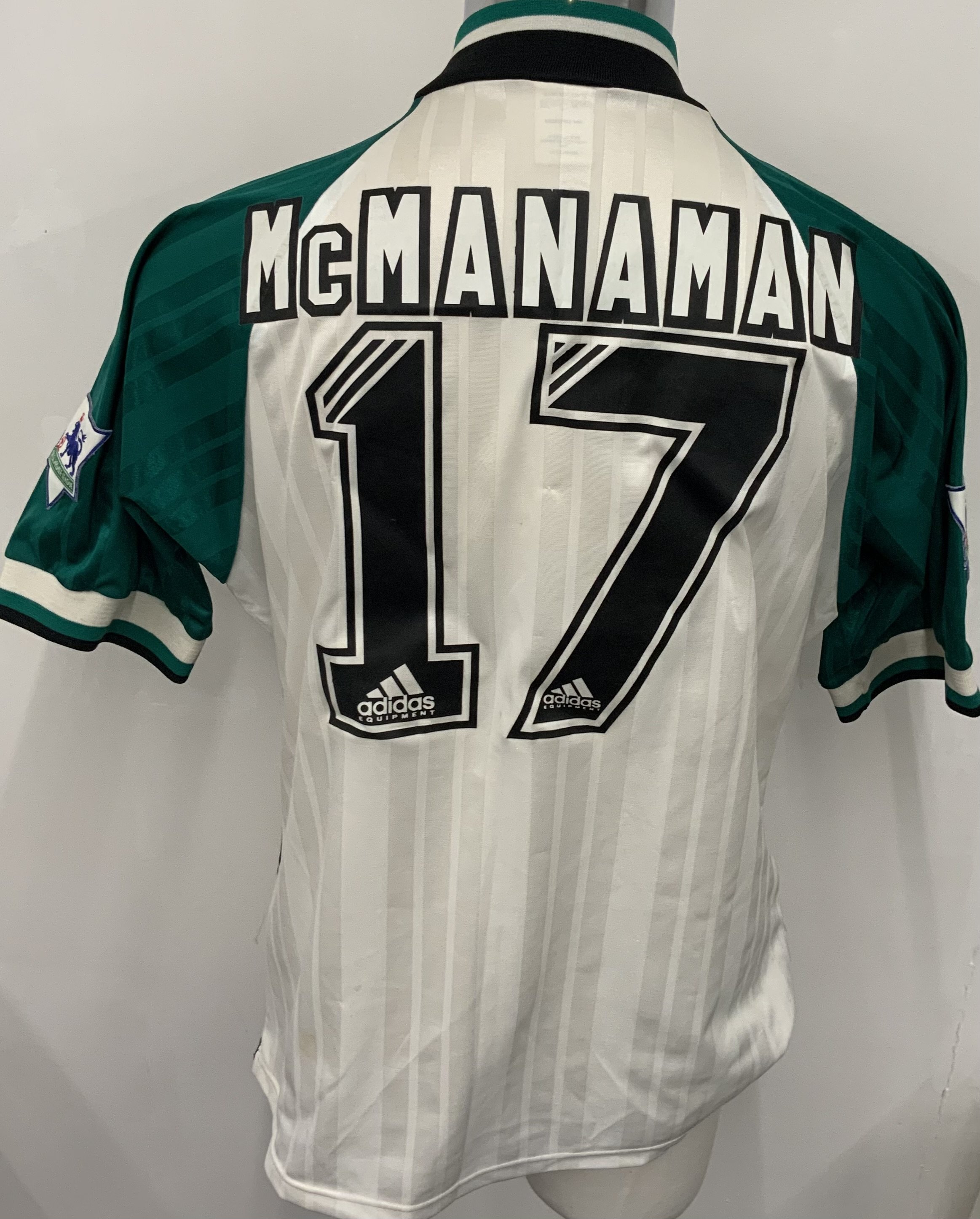 Liverpool 1993 - 1995 Match Worn Signed Football Shirt: Green white and black Carlsberg Adidas short sleeve shirt with Premier League badging to sleeves. Number 17 McManaman to rear. Staining to front which is signed by 11 players including Rush and Clough. 