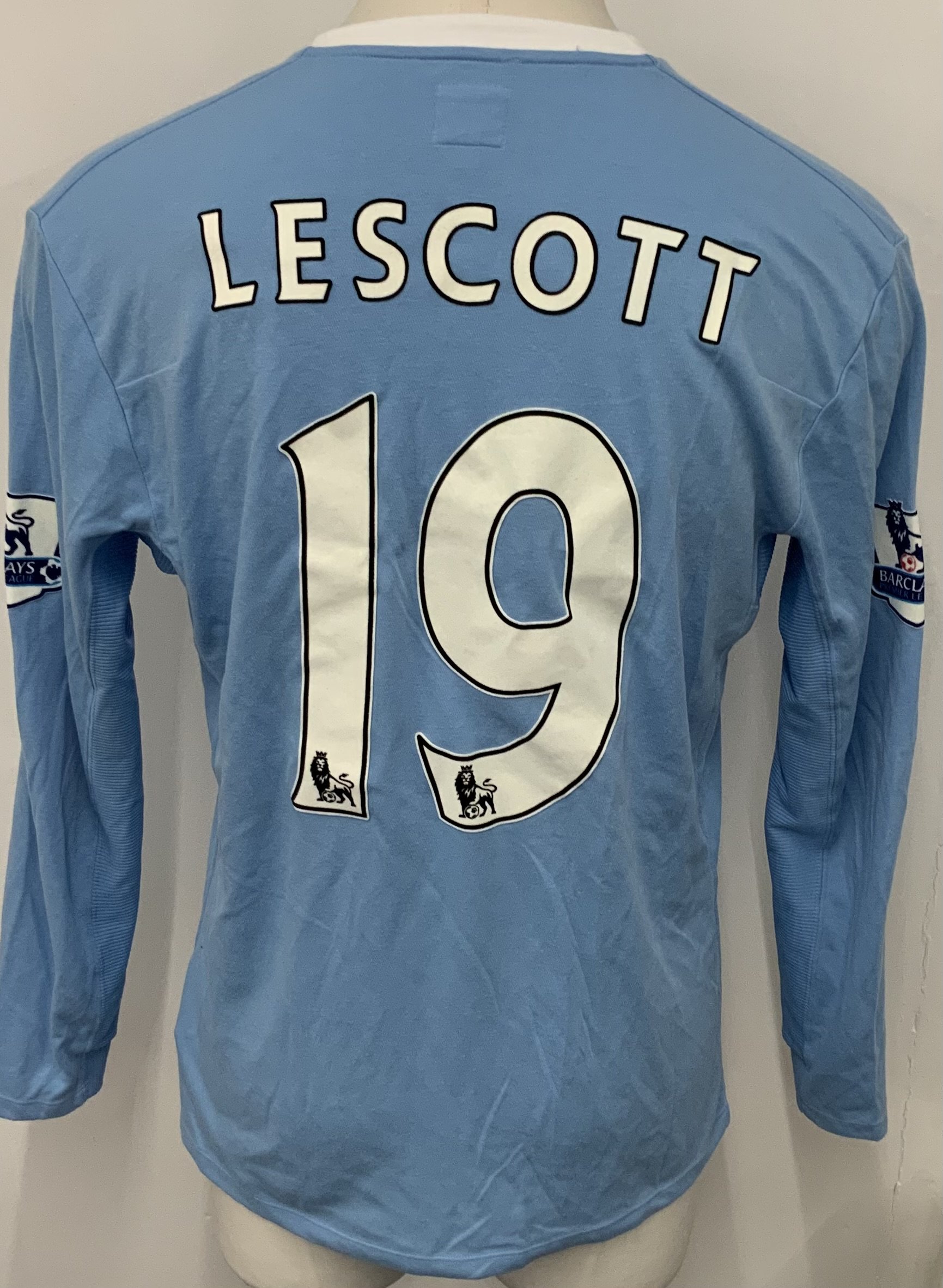 Manchester City 2009 - 2010 Lescott Match Worn Football Shirt: Blue long sleeve Umbro shirt from 1st season of Etihad Sponsorship. Premier League badging to sleeve and Lescott 19 to rear. 
