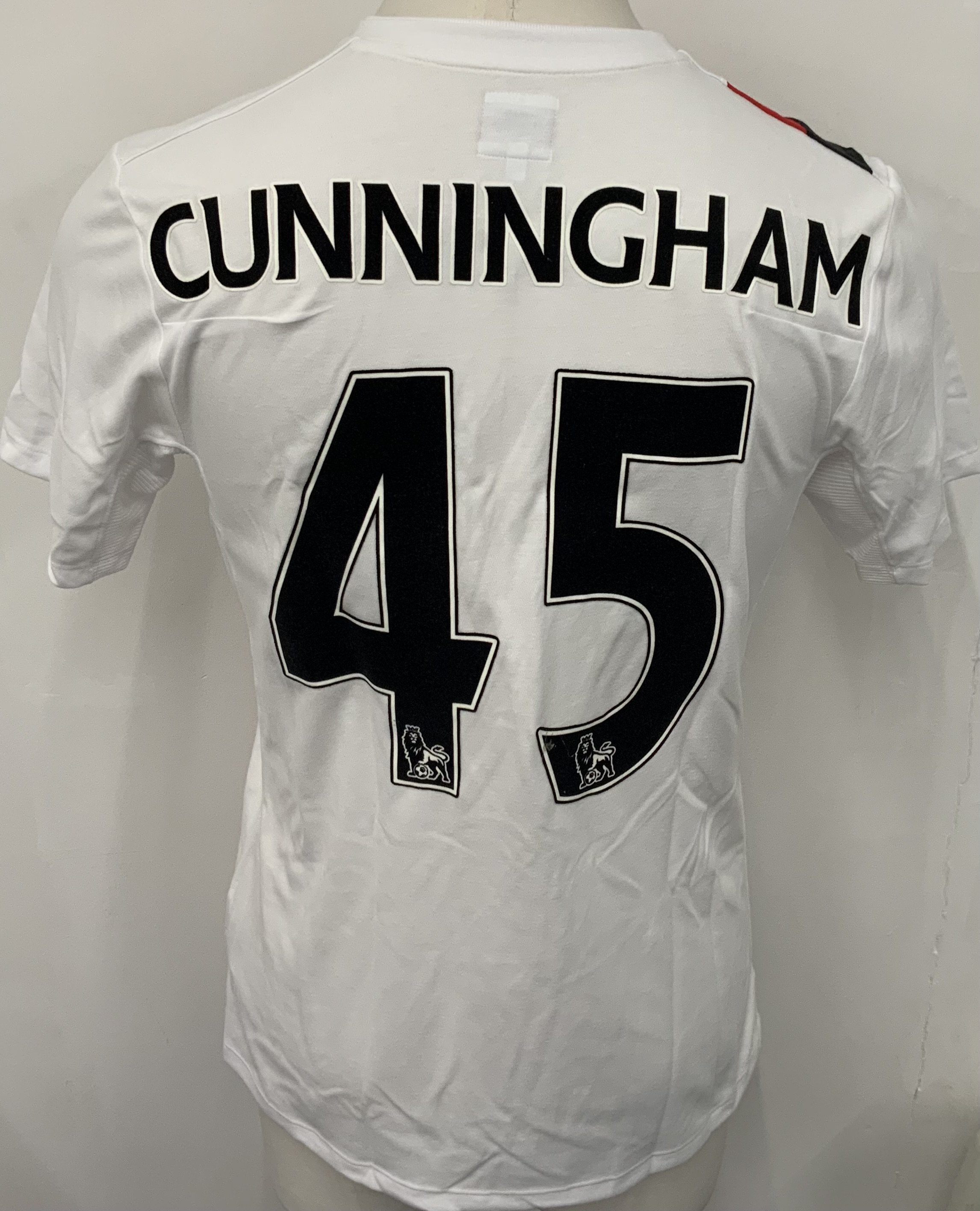 Manchester City 2009 - 2010 Cunningham 3rd Kit Match Issued Football Shirt: White with red and black slash short sleeve Umbro shirt from 1st season of Etihad Sponsorship. No badging to sleeve and Cunningham 45 to rear. Possibly issued/worn in pre season friendly. 