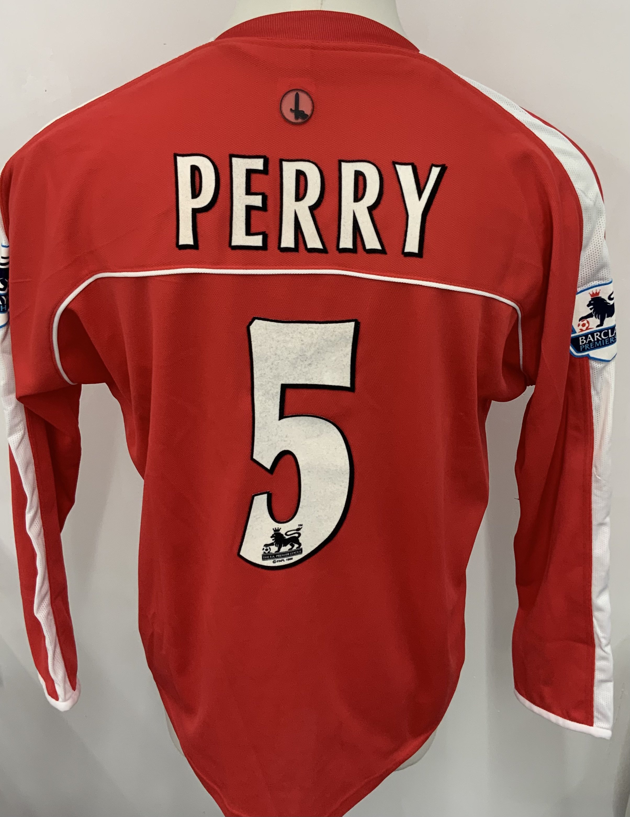 Charlton Athletic 2003 - 2005 Match Worn Football Shirt: Red long sleeve shirt. Number 5 Perry. PremierLeague badging. Unwashed shirt.