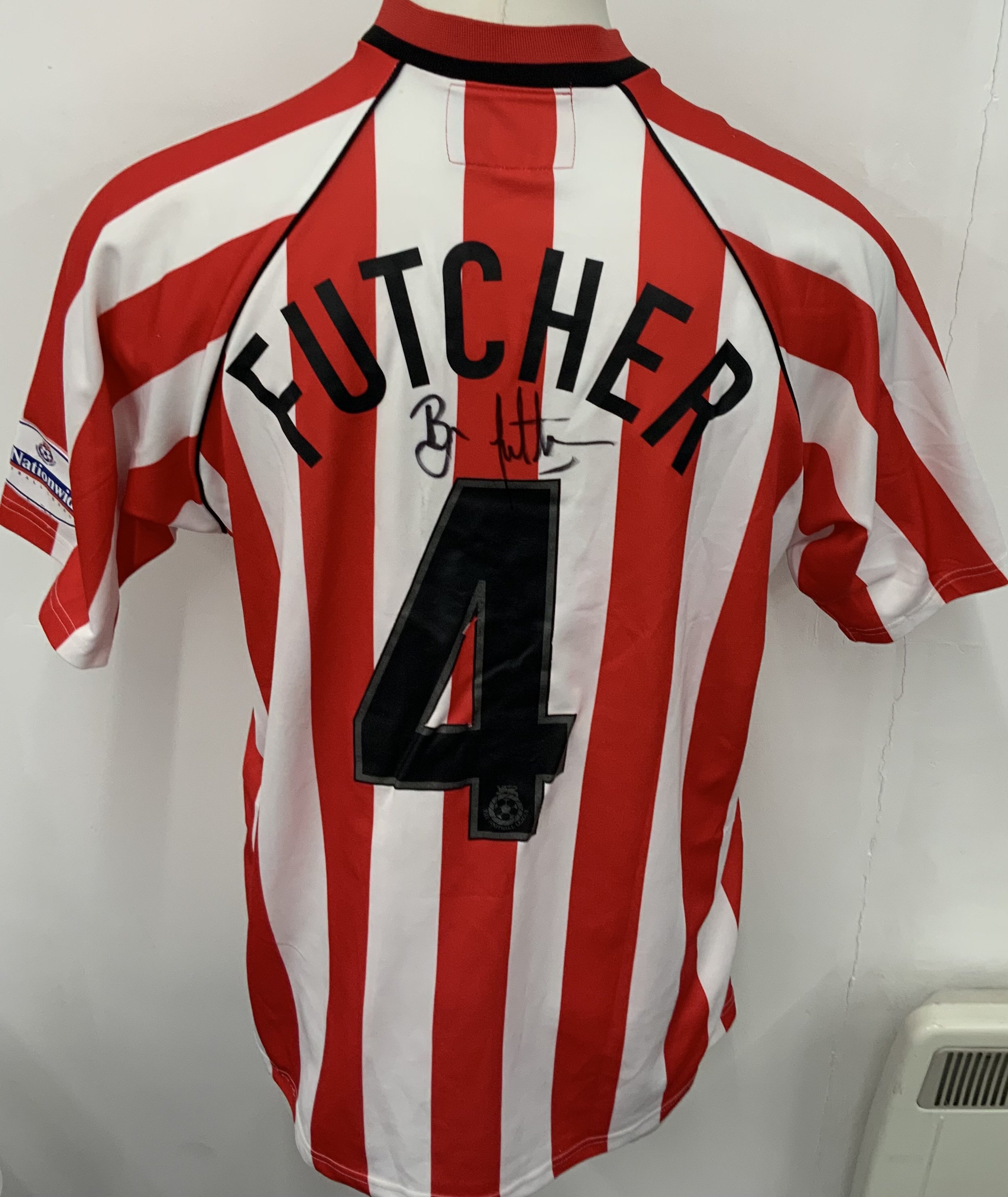 Lincoln City 2002 - 2003 Match Worn Football Shirt: Red and White long sleeve shirt. Number 4 Futcher. Nationwide sleeve badging with one badge missing. Signed by the player. 