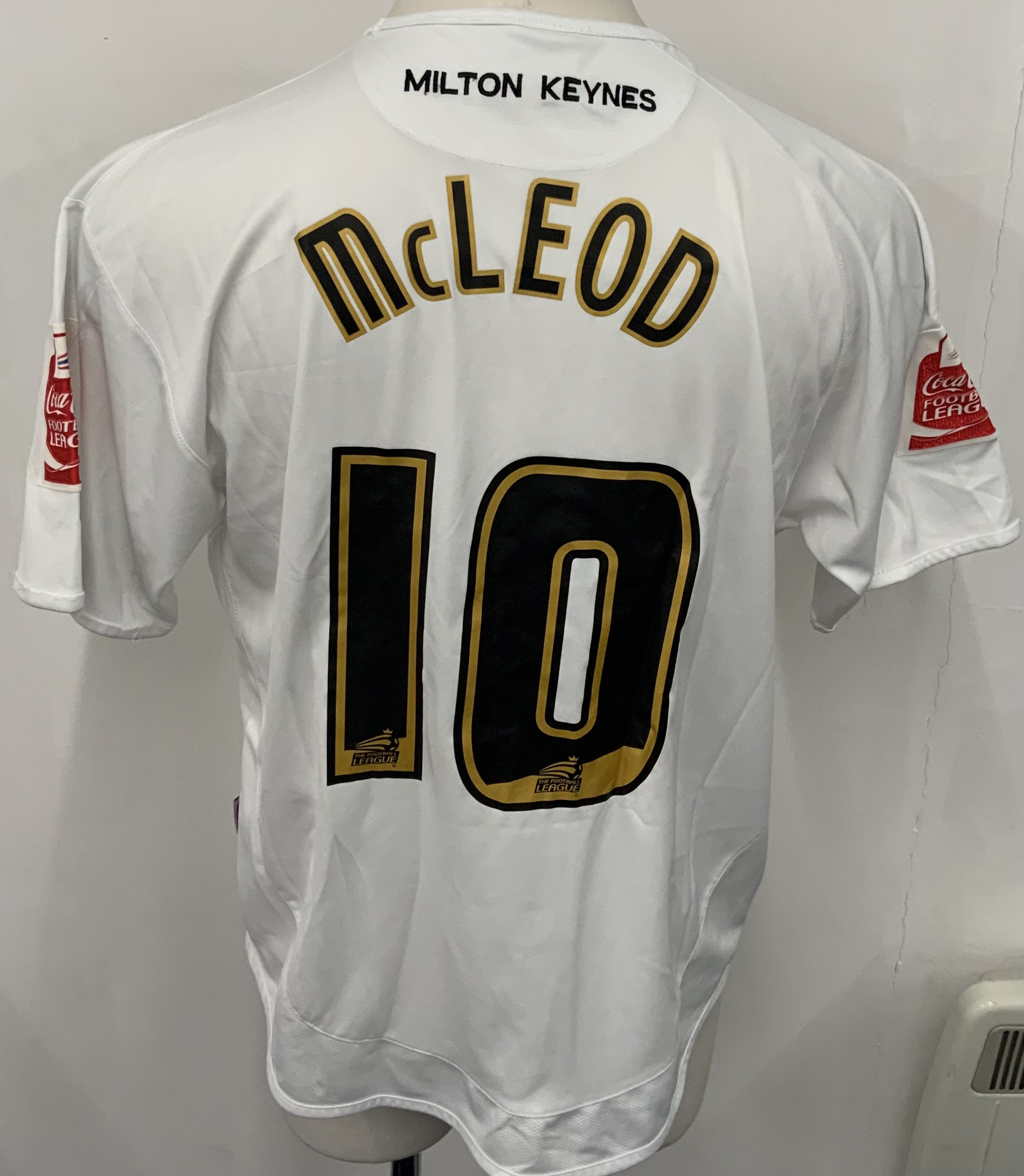 MK Dons 2006 - 2007 Match Worn Football Shirt: White short sleeve Marshall sponsored shirt with Coca Cola Football League badging to arms. Number 10 McLeod to rear. Worn v Tottenham in the Coca Cola Cup.