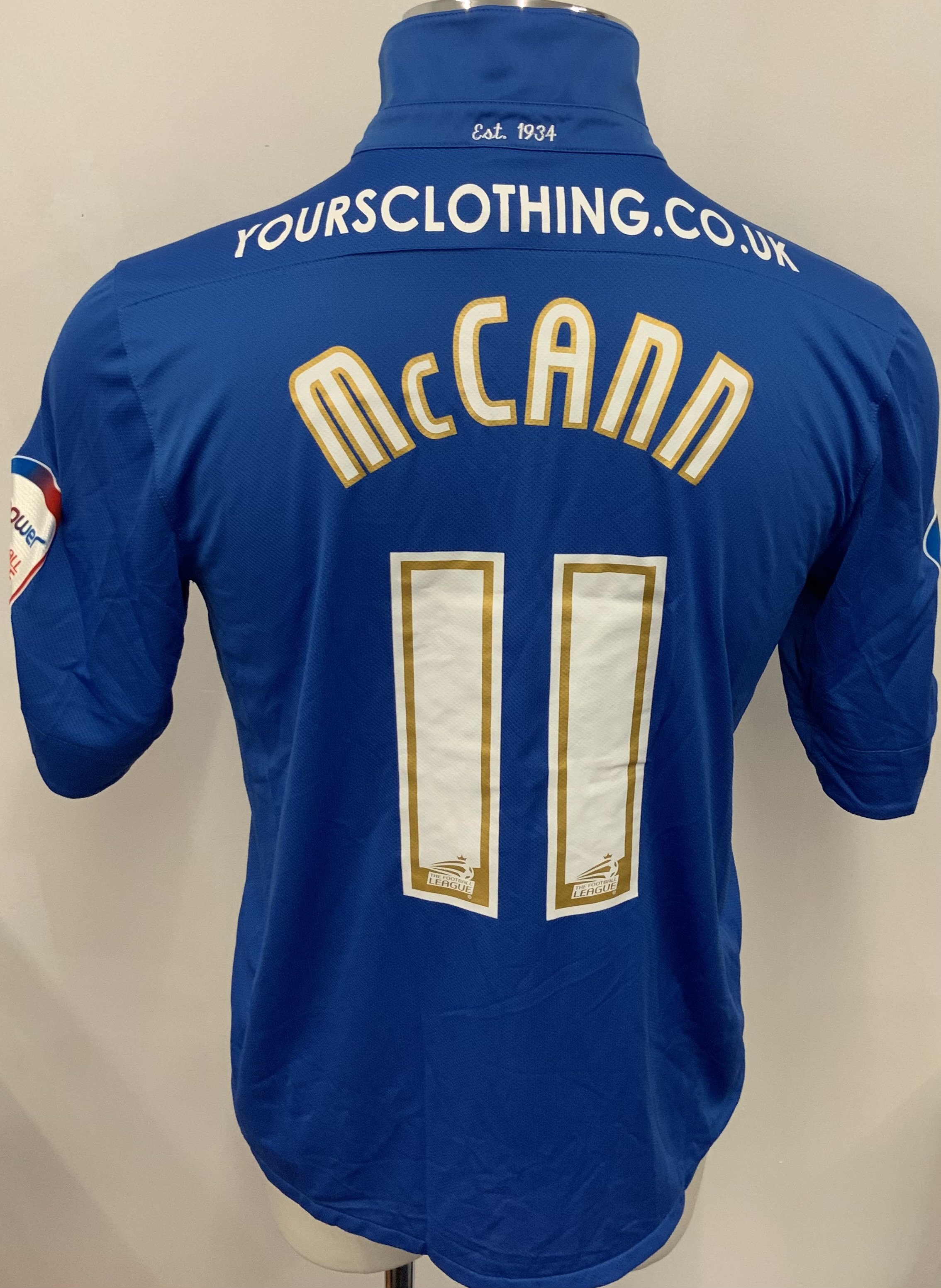 Peterborough United 2012 - 2013 Match Worn Football Shirt: Blue short sleeve shirt. Number 11 McCann. NPower League badging. 