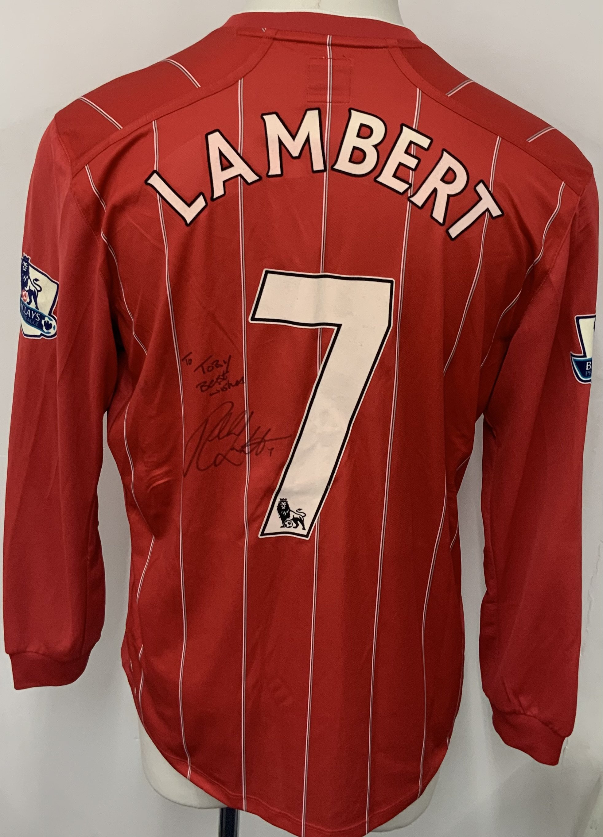 Southampton 2012 - 2013 Match Worn Lambert Football Shirt: Red long sleeve home shirt with Premier League sleeve badging. Signed to front and back with dedication. Number 7 Lambert to reverse. 