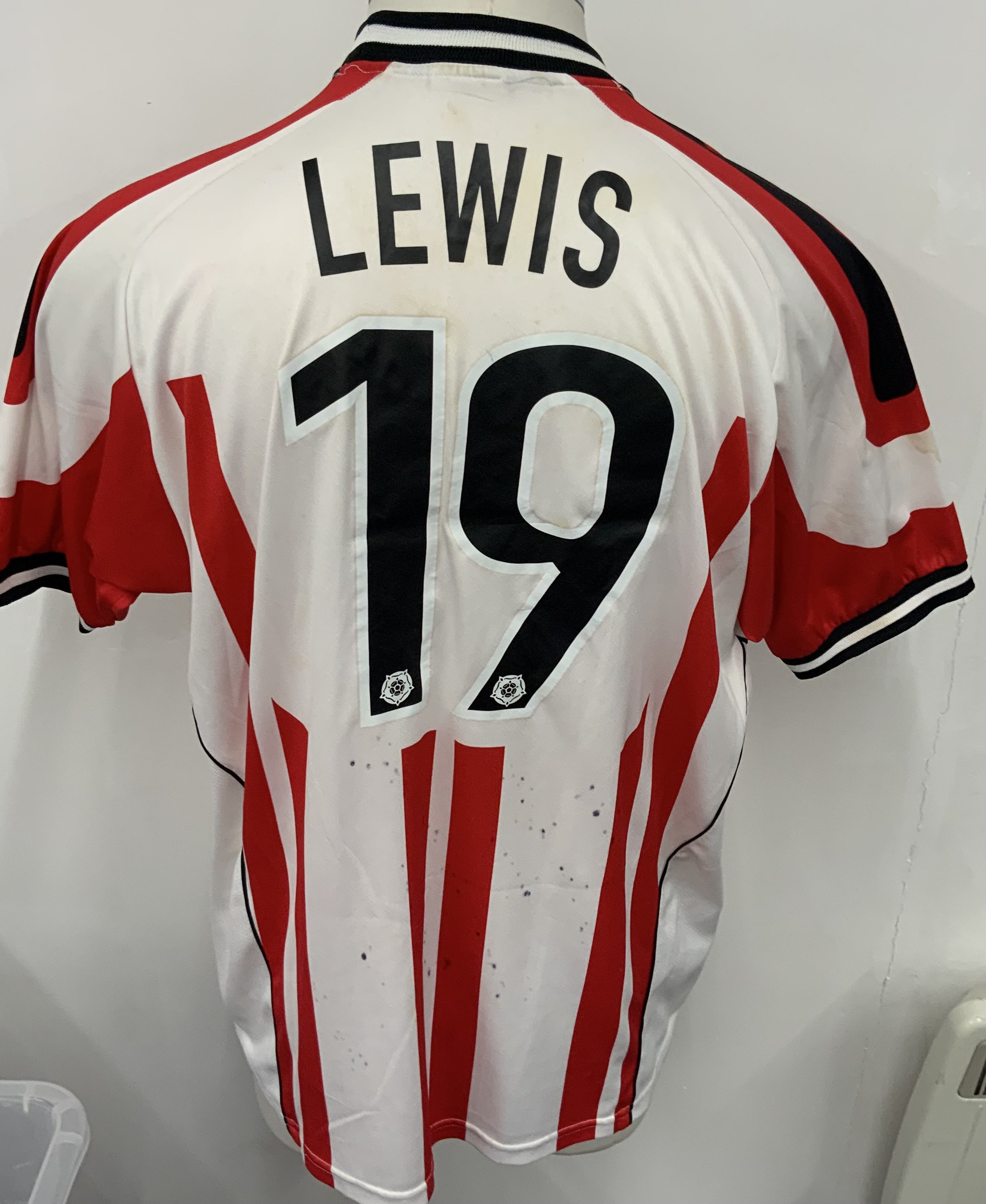 Stevenage 2007 - 2008 Match Worn Football Shirt: Red and White short sleeve shirt. Number 19 Lewis. Signed with dedication. Ink marks bled to rear