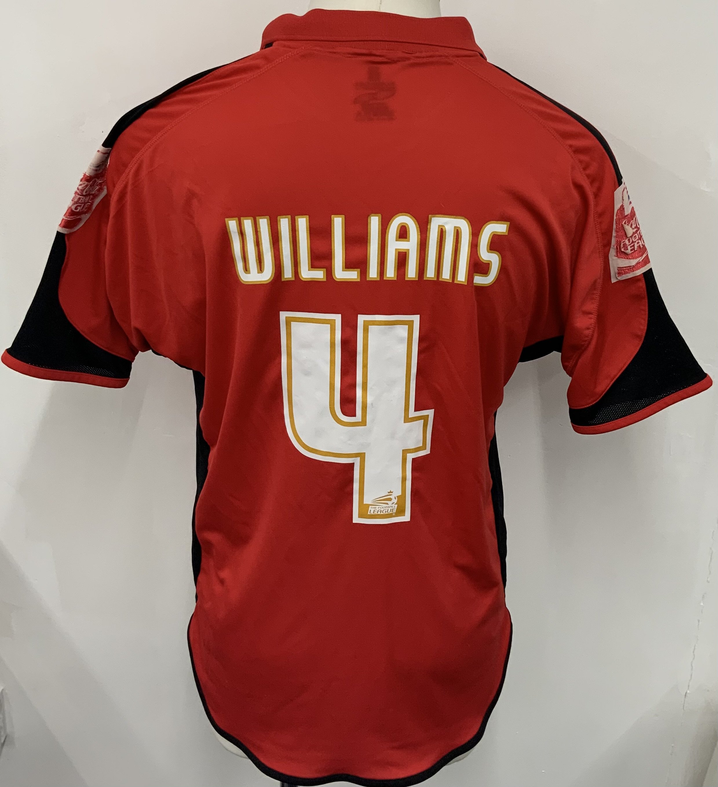 Accrington Stanley 2007 - 2008 Match Worn Football Shirt: Red short sleeve Fraser Eagle sponsored shirt with Coca Cola Football League badging to arms. Number 4 Williams to rear. Sponsorship and sleeve badging wear. Williams infamously got banned at the end of this season. 