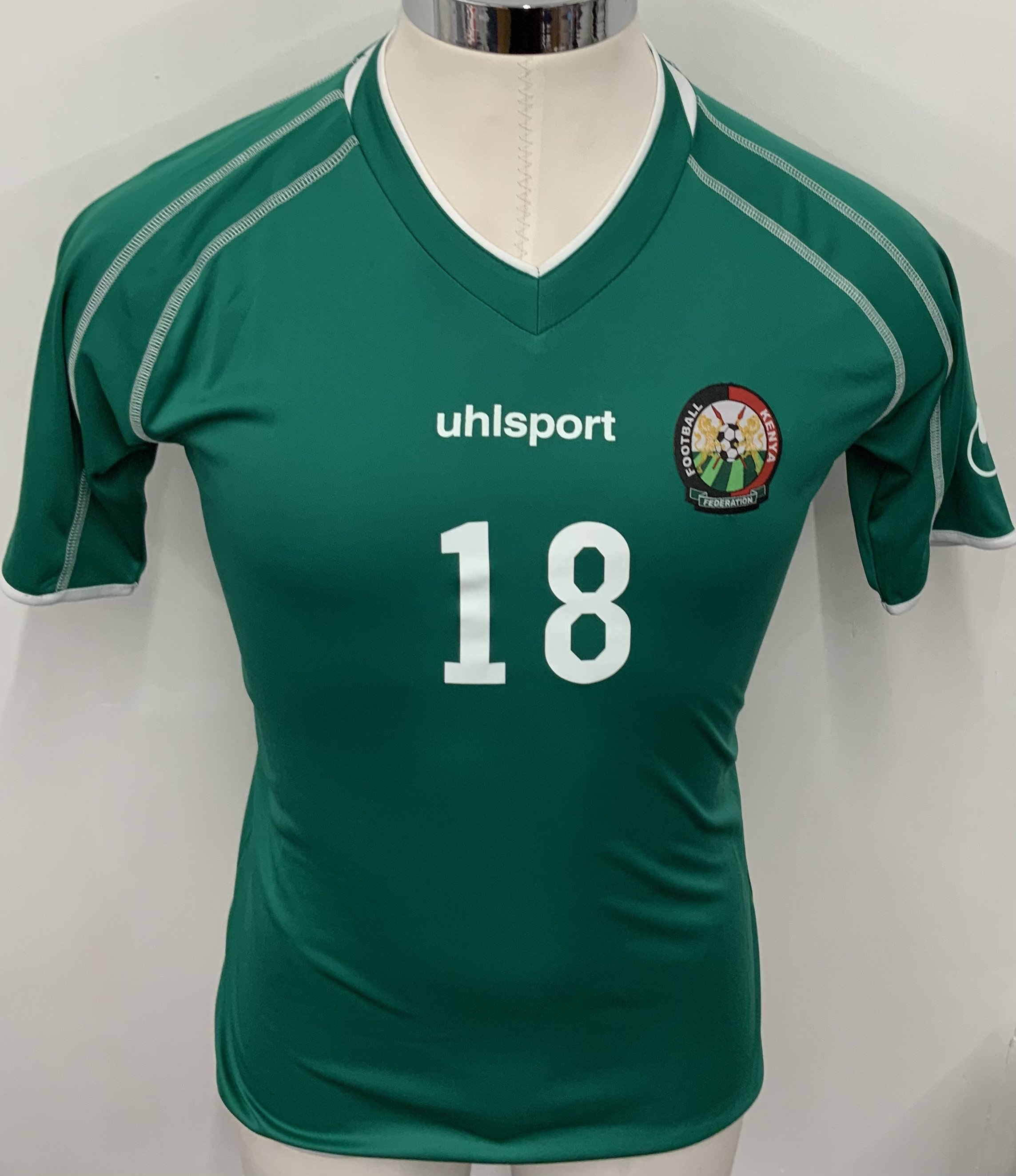 Kenya Match Worn Football Shirt: Green short sleeve Uhlsport shirt with number 18 to front and back. 