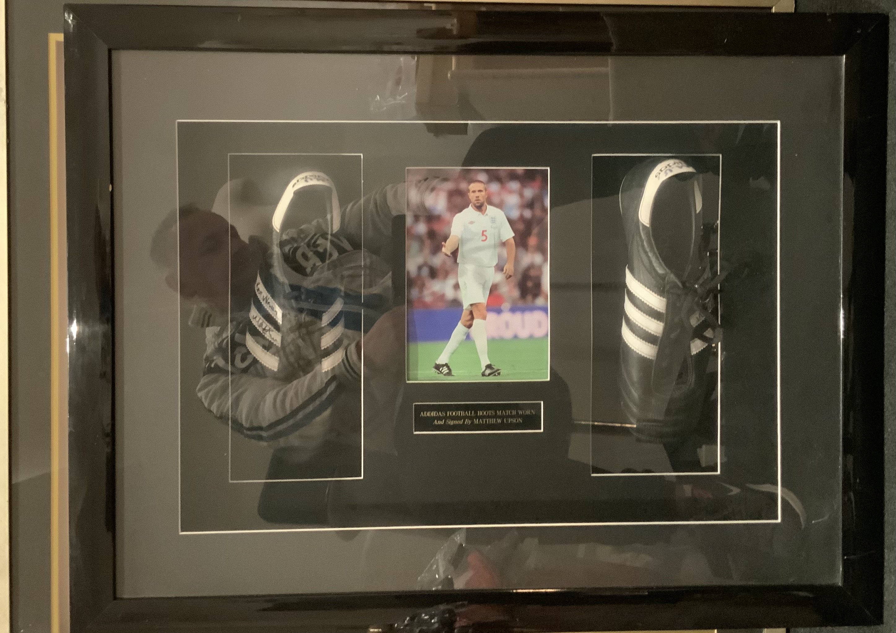 Mathew Upson Match Worn England Framed Adidas Football Boots: Expensively framed in deep frame. Plaque states worn and signed by Mathew Upson. Both boots are signed by the player and are pictured with him wearing them playing for England. Not for posting.