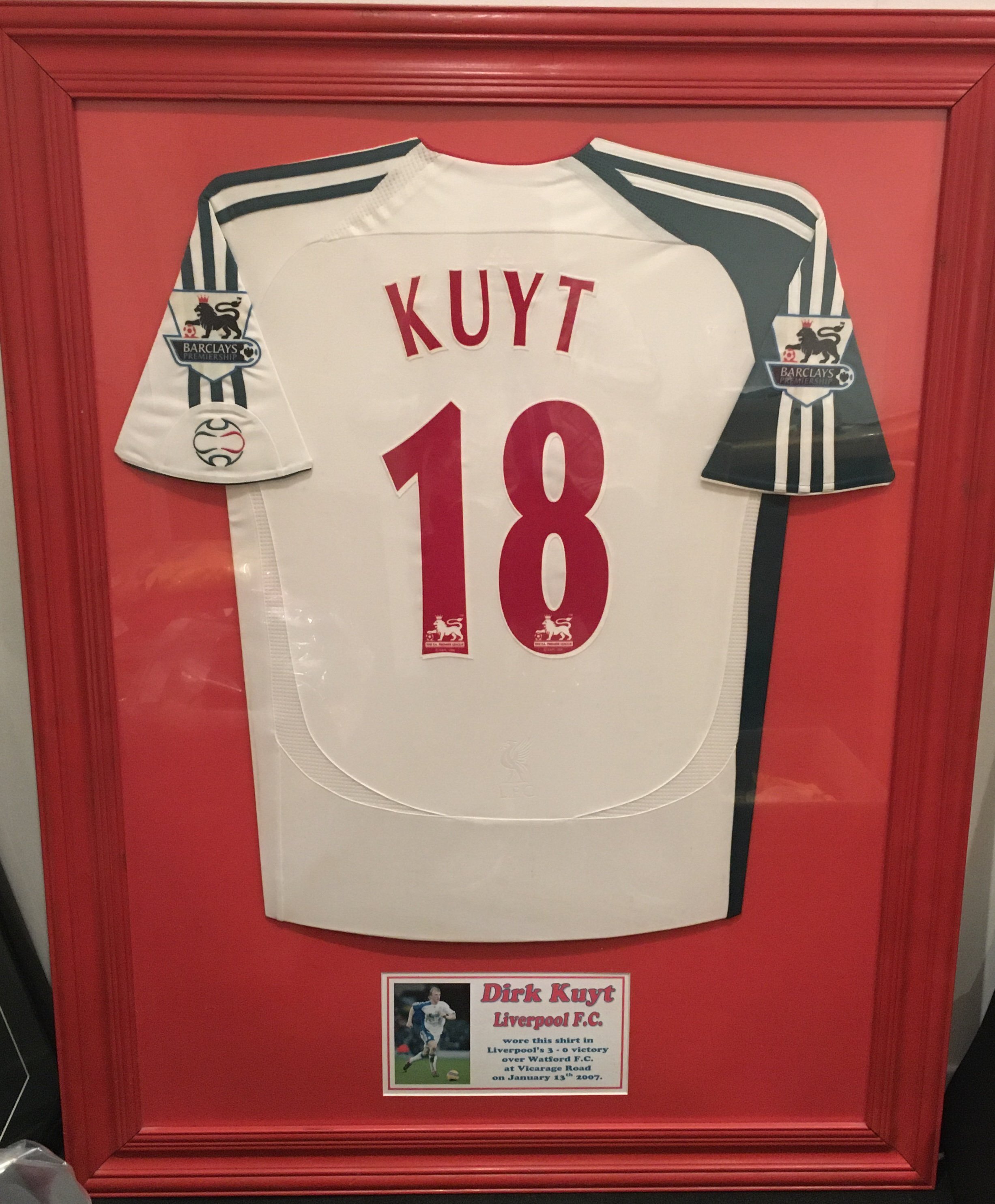 Dirk Kuyt Liverpool 2006 - 2007 Match Worn Framed Football Shirt: White short sleeved away shirt with Premier League badging and Kuyt 18 to rear. Worn in 3-0 win at Watford on 13 1 2007. Beautifully and expensively framed. Not for posting.