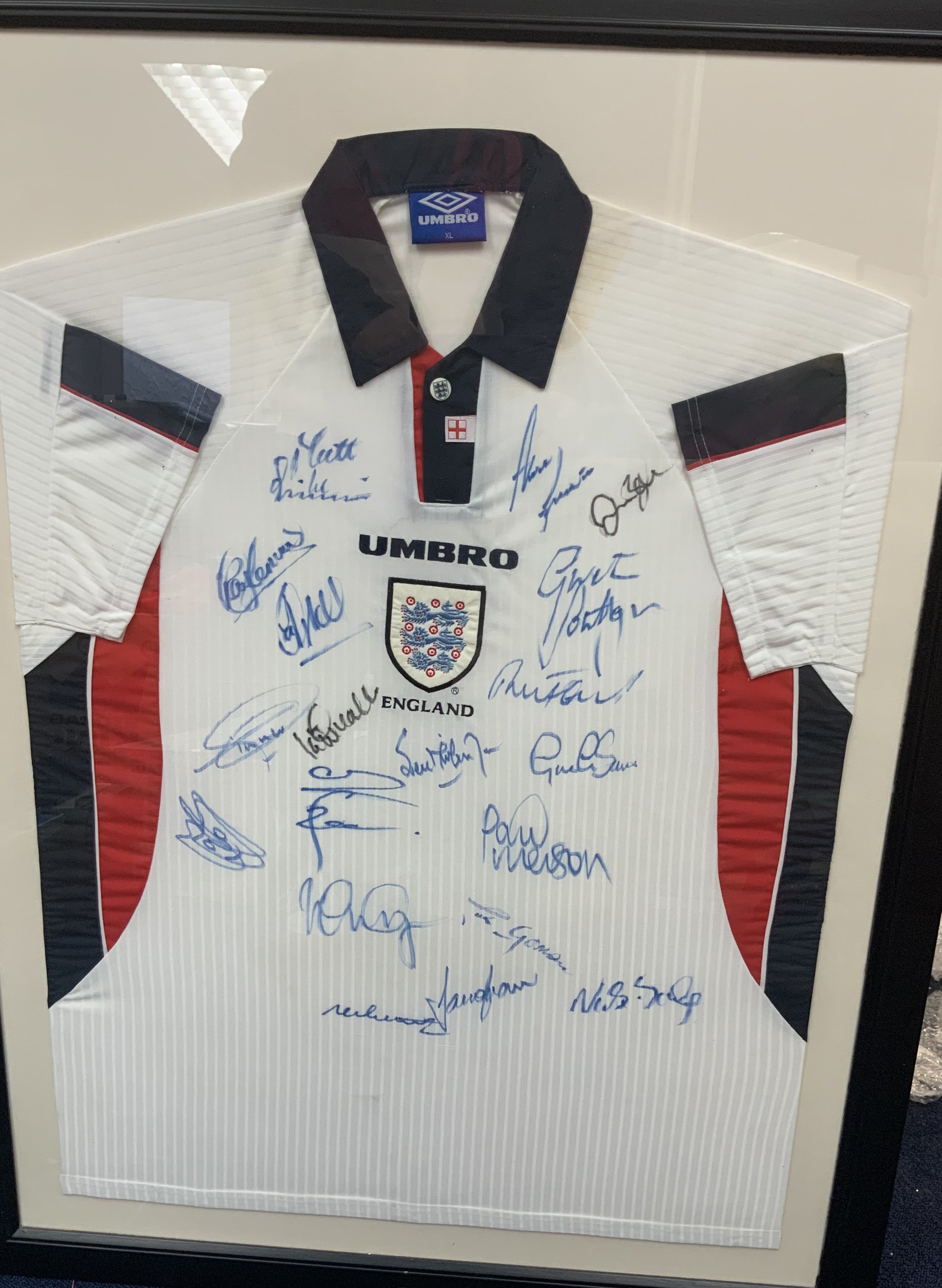 England 1998 Framed Signed Football Shirt: Squad signed to front. Includes Shearer Merson Clemence Southgate James Beckham and Le Tissier,  in fact 19 autographs in total. Frame measures approximately 42 inches by 32 inches. No COA. Not for posting. 