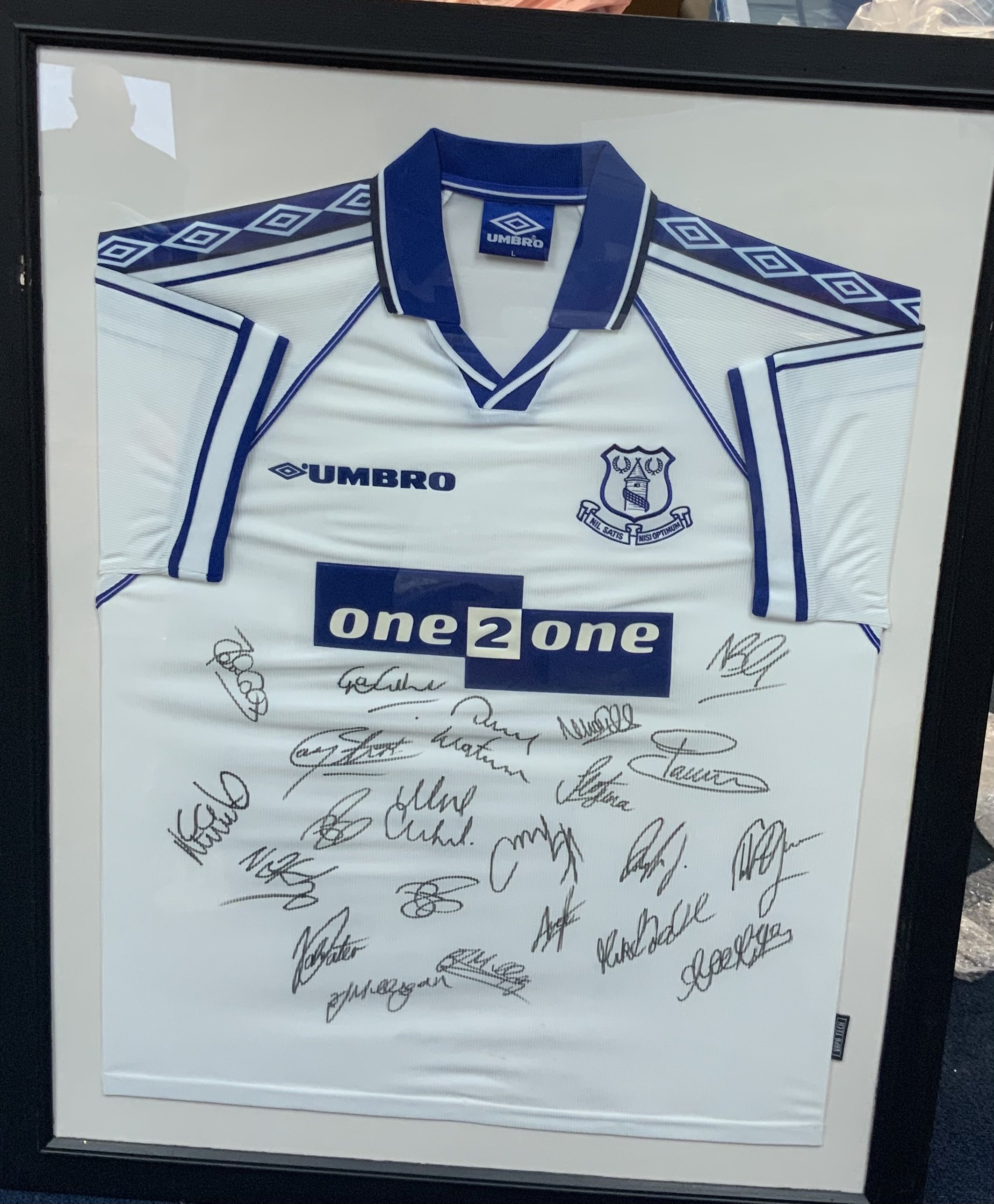 Everton 1998 - 1999 Signed Framed Football Shirt: Squad signed white original large Umbro shirt. Frame measures approximately 38 inches by 30 inches. No COA. Not for posting.