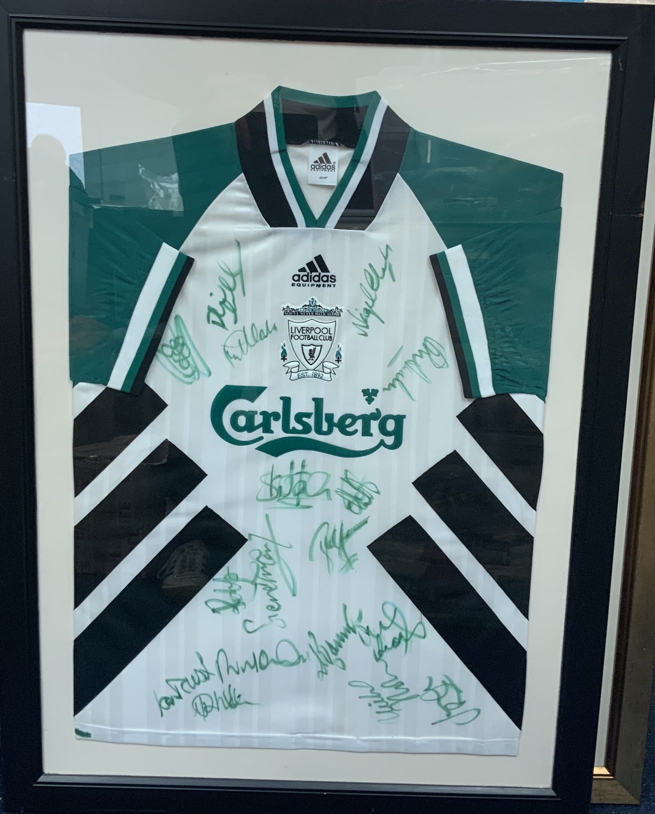 Liverpool 1994 - 1995 Signed Framed Football Shirt: Green and white original Carlsberg size 40-42 away shirt. Multi signed by squad in matching green. Frame measures approximately 38 inches x 28 inches. Not for posting. 

