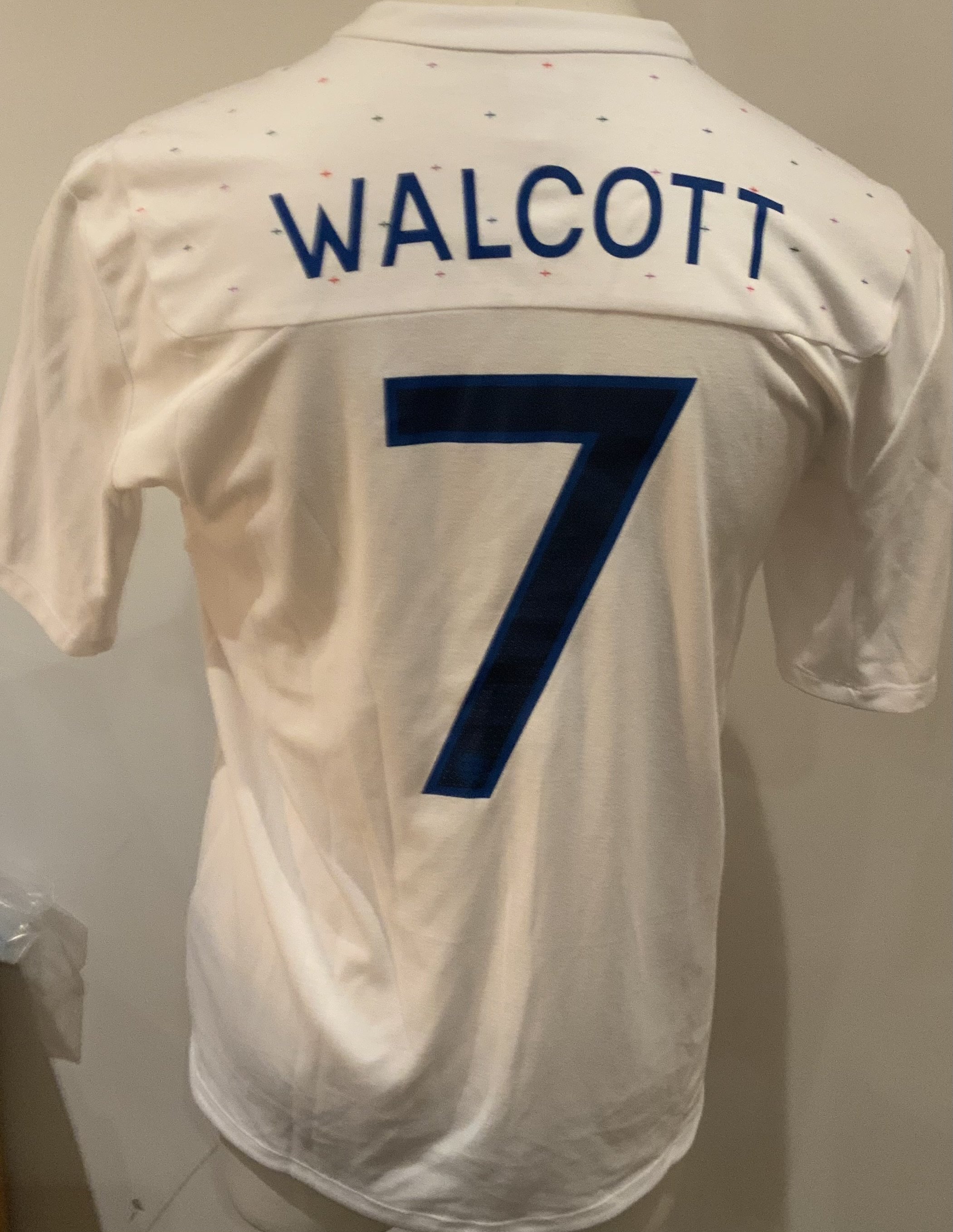 England 2011 Match Worn Football Shirt: White short sleeve shirt with Walcott 7 to rear. Worn in the match v Denmark on 9 February 2011.