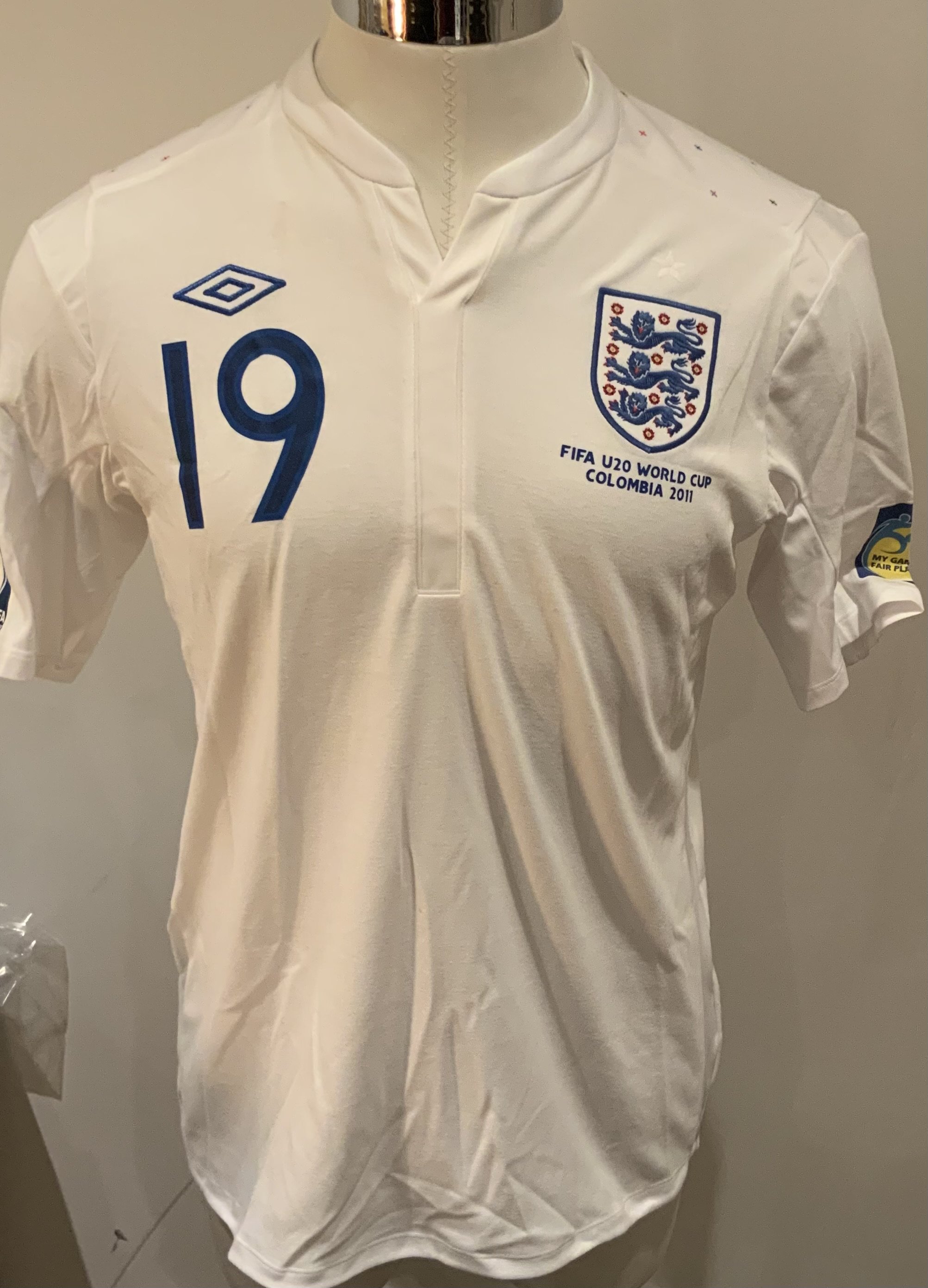 England 2011 Match Worn Under 20 Football Shirt: White short sleeve shirt with Wabara 19 to rear. Worn in the Under 20 World Cup Tournament in Columbia. Wabara played in every match. 