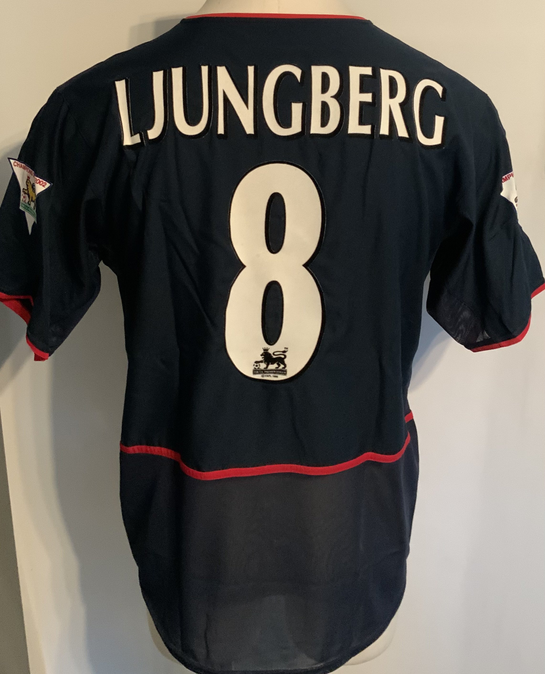 Arsenal 2002 - 2003 Away Match Worn Football Shirt: Blue short sleeve Nike shirt with Premier League Champions 2001 - 2002 badging to sleeves. Ljunberg 8 to rear. Worn v Sunderland on 11 May 2003. Comes with signed COA from the player who scored 3 goals in the match.