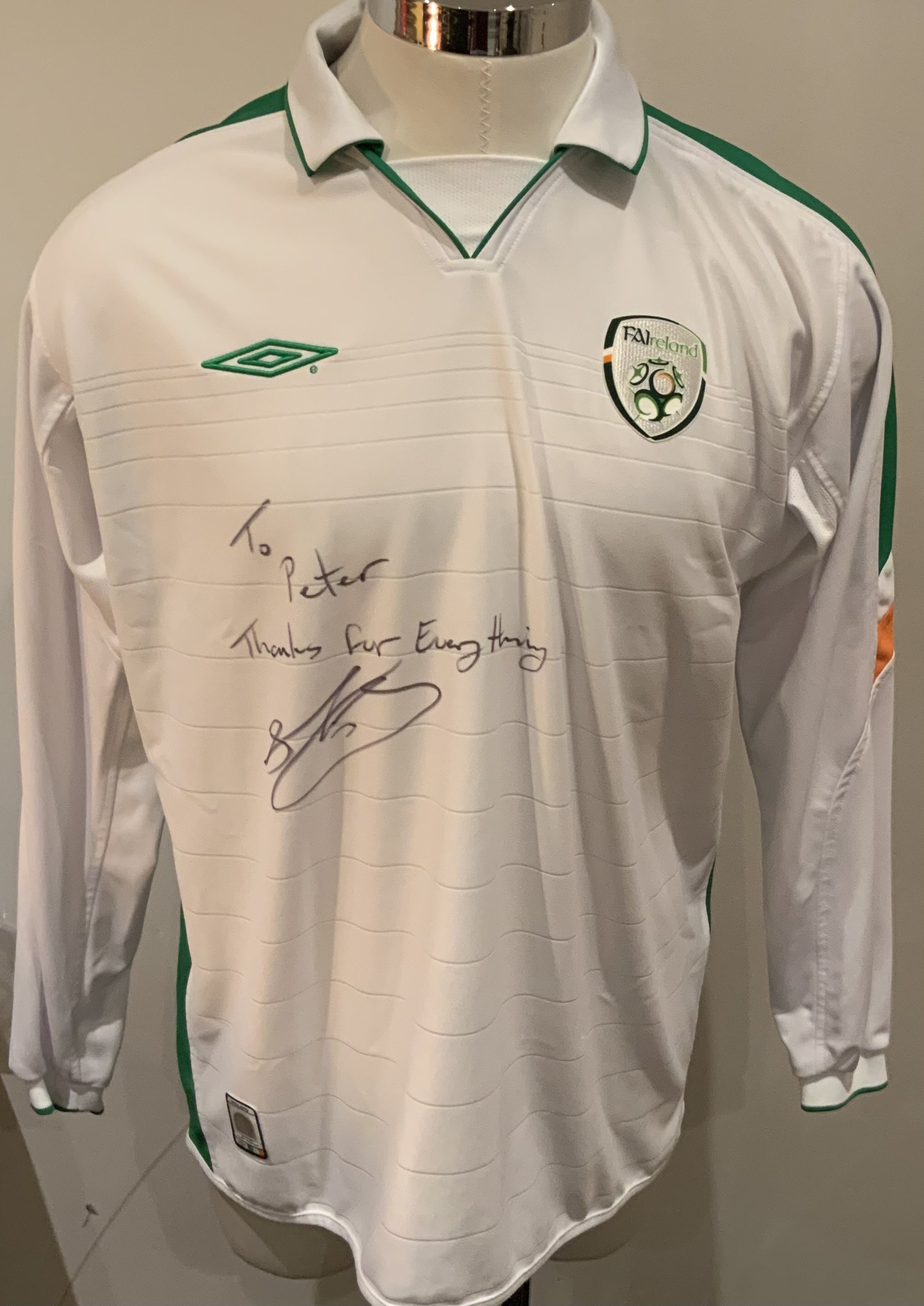 Republic of Ireland Football Shirt: White long sleeve shirt. Number 4 and signed to front with dedication by Stephen Kelly. Not believed to be match worn but given by Kelly to our source. 