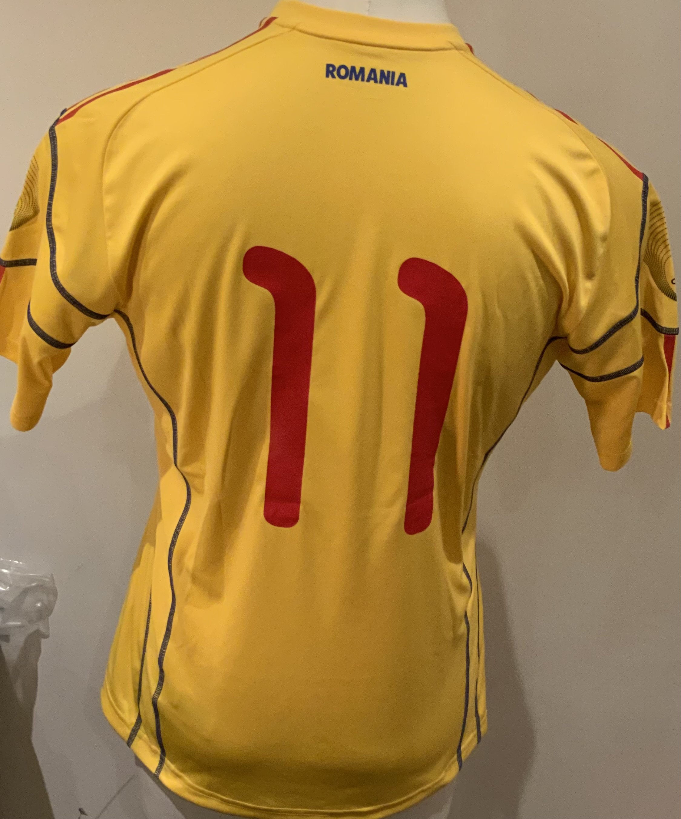 Romania Match Worn Football Shirt: Yellow short sleeve shirt with number 11 to rear. Worn v Italy on 17 November 2010 by Gabriel Torje in a friendly match that ended 1-1.