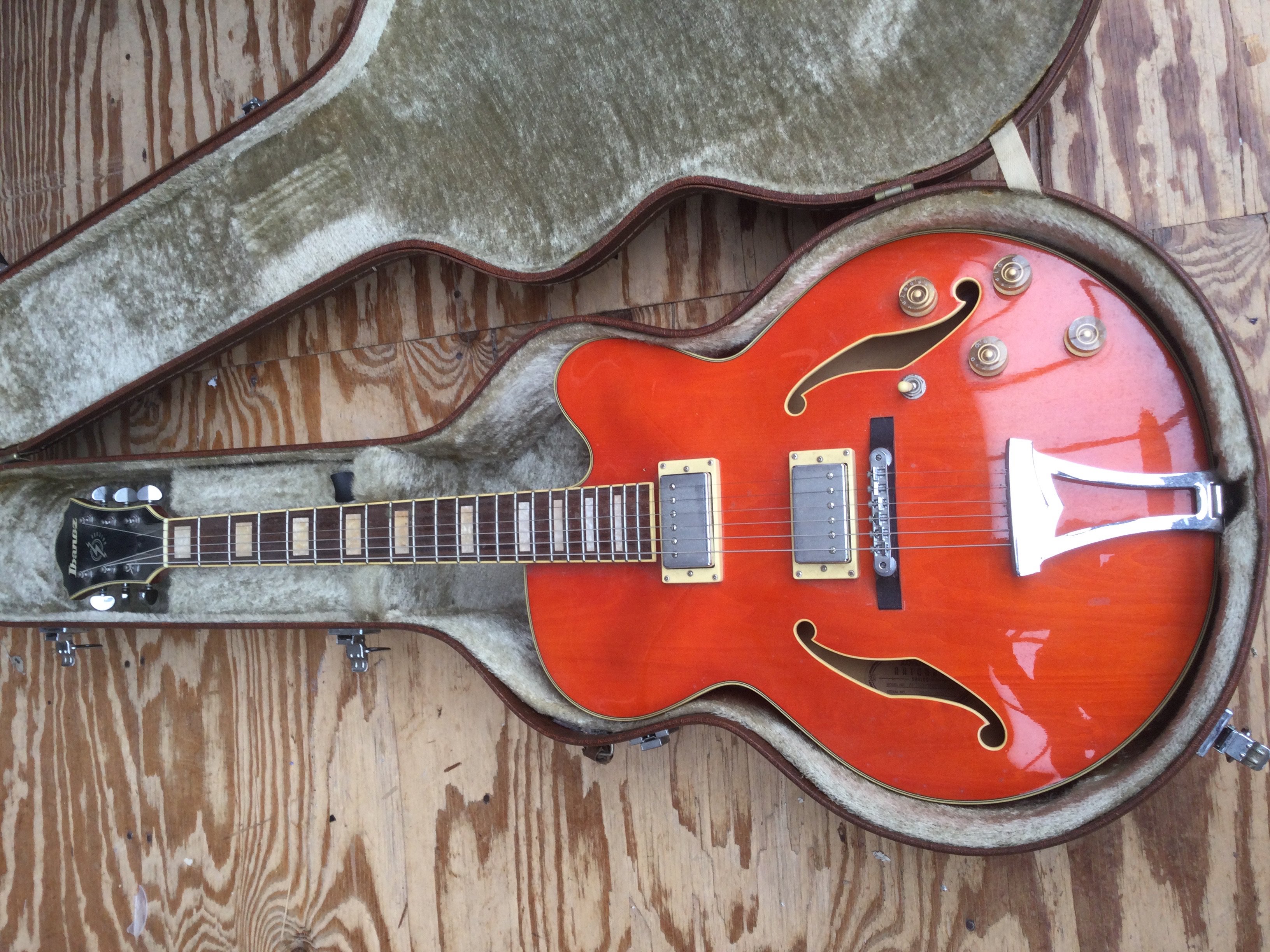 An Ibanez Artcore series AF75D electric guitar in orange. Comes with hard carry case.
