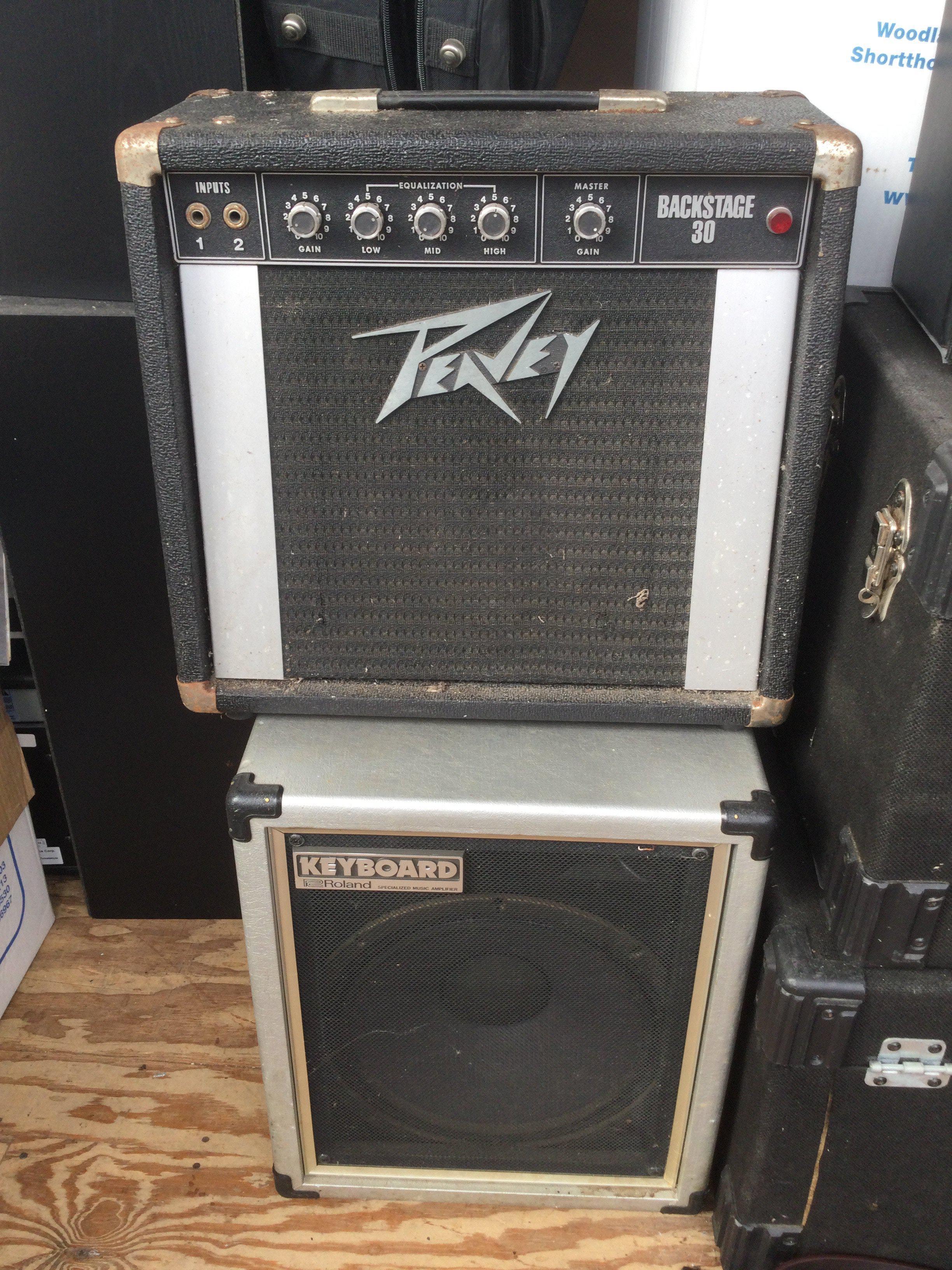 Two amplifiers comprising a Roland Cube 60 and a Peavey Backstage 30.