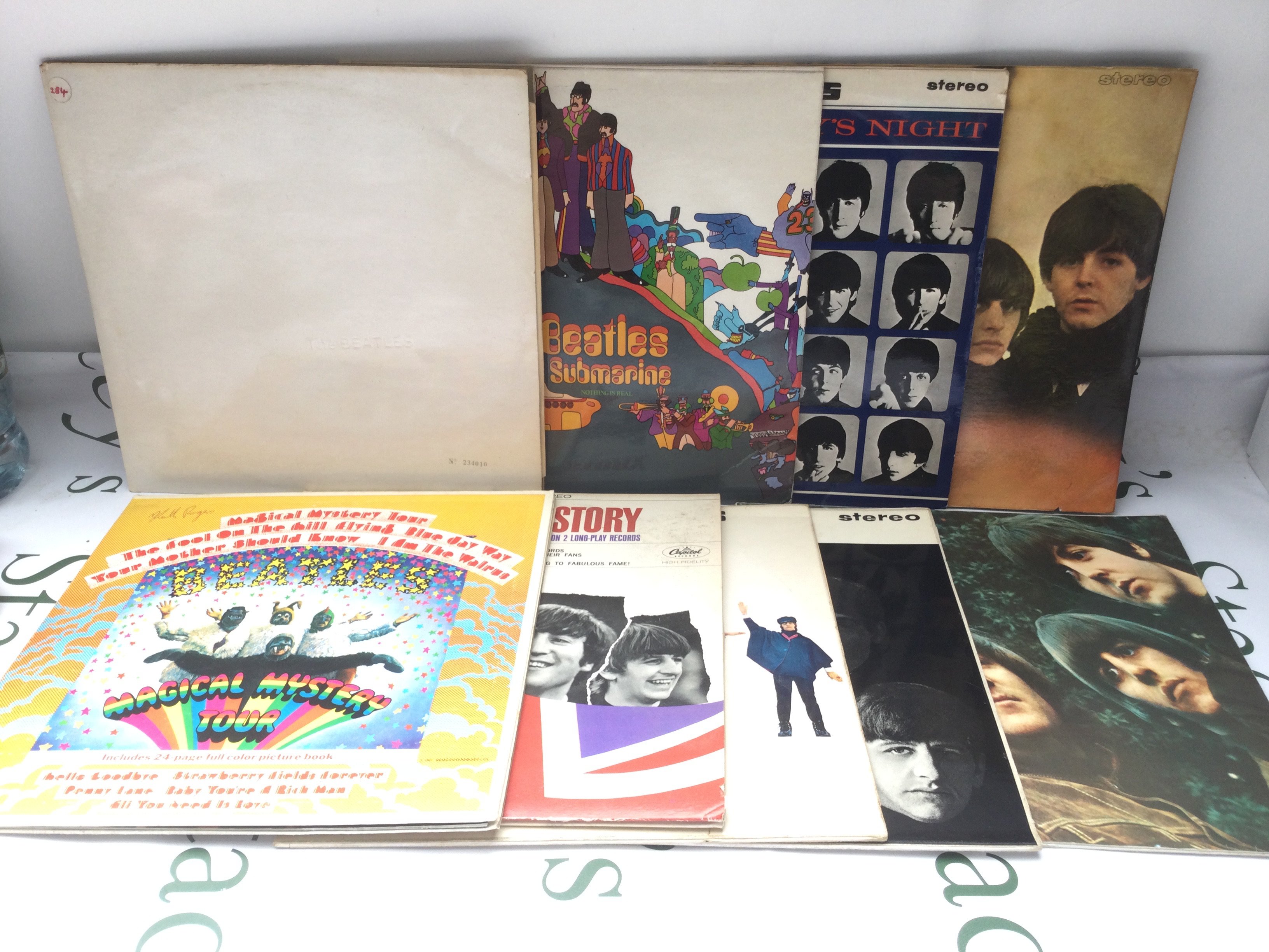 Two bags containing 18 Beatles LPs comprising UK and US pressings including an early 1970s numbered and side loading 'White Album', 234010, Magical Mystery Tour, Yellow Submarine and others.