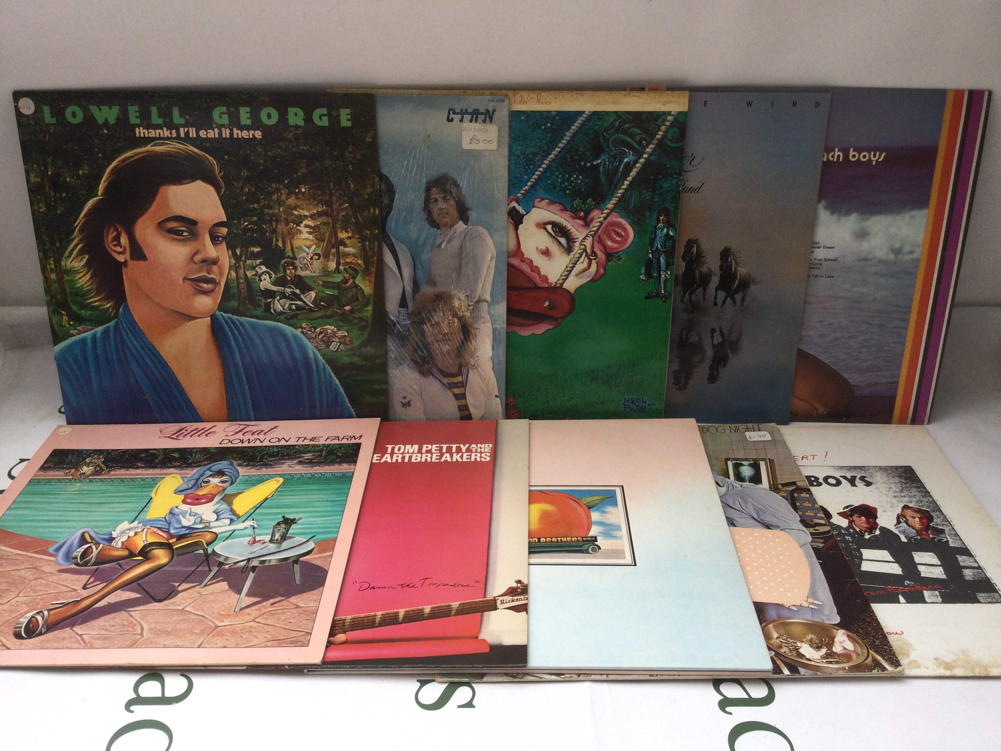 Two bags containing twenty 1970s rock and pop LPs by various artists including Little Feat, Tom Petty, Iggy Pop and others.