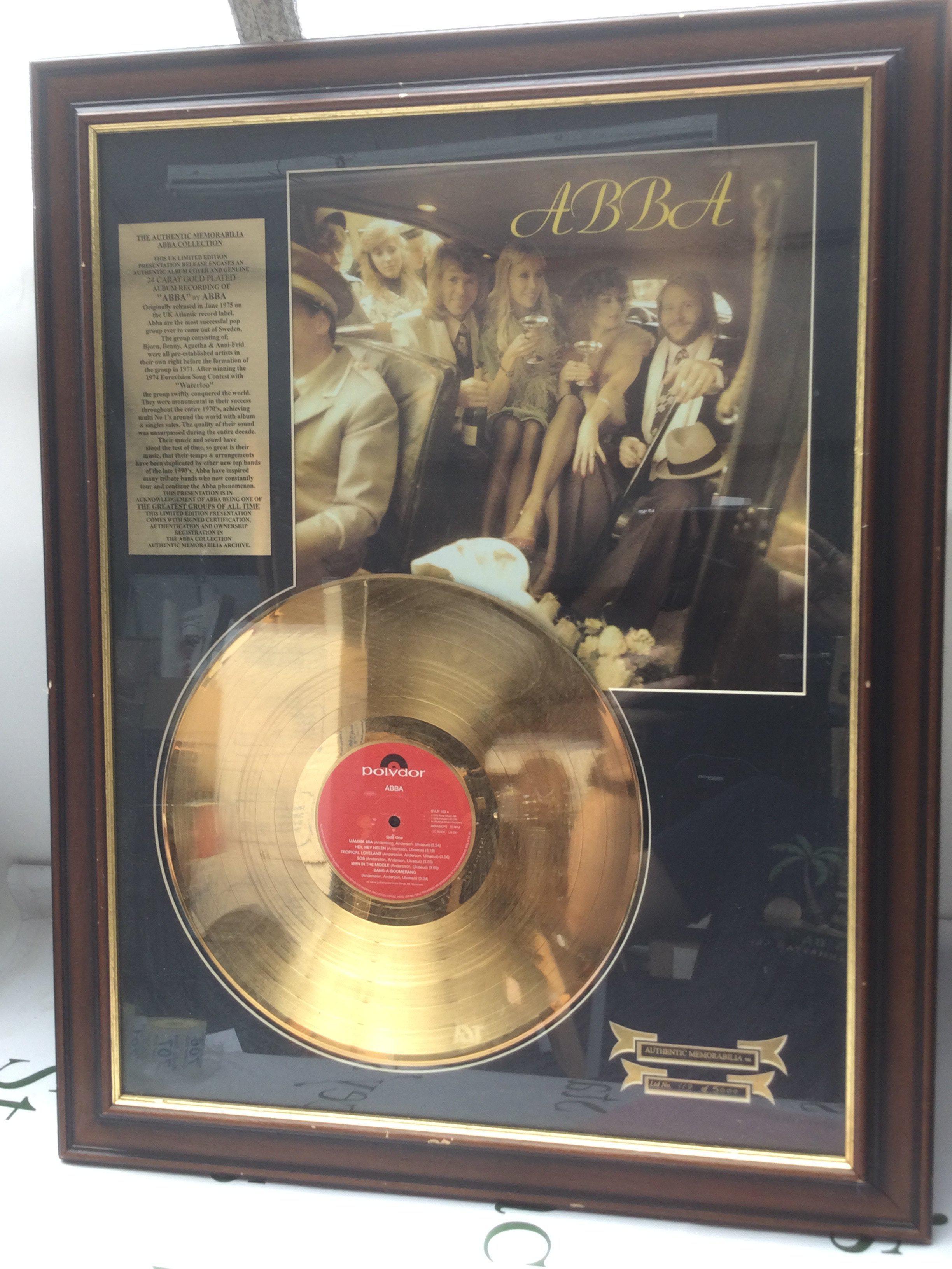 A framed and glazed limited edition gold disc of the self titled Abba LP, numbered 119/5000, with COA to reverse.