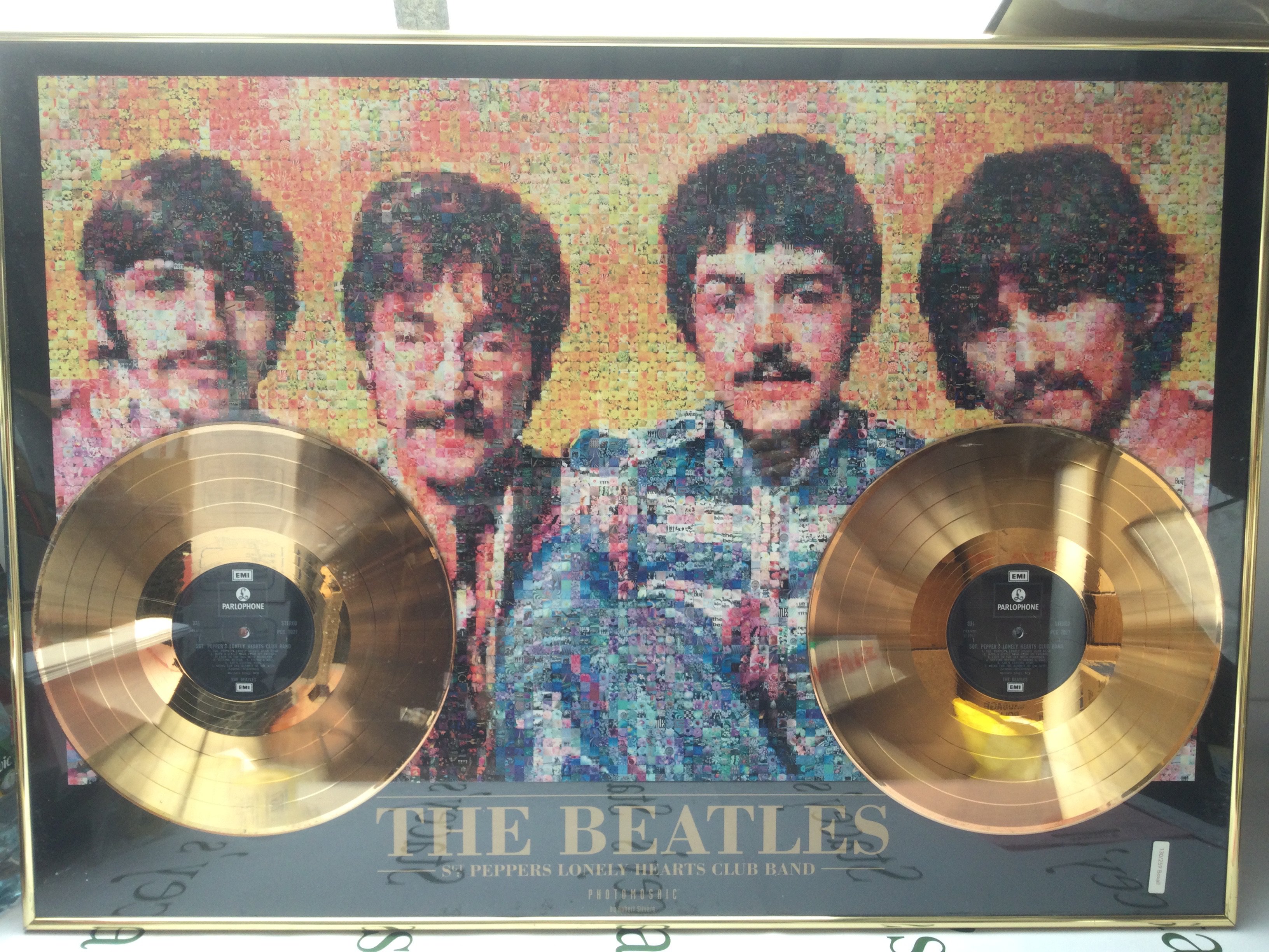 A framed and glazed limited edition double gold disc and photomosaic display for The Beatles' Sergeant Pepper's Lonely Hearts Club Band album. Numbered 003/500. Comes with a framed and glazed Moody Blues CD display with facsimiling signatures (2).