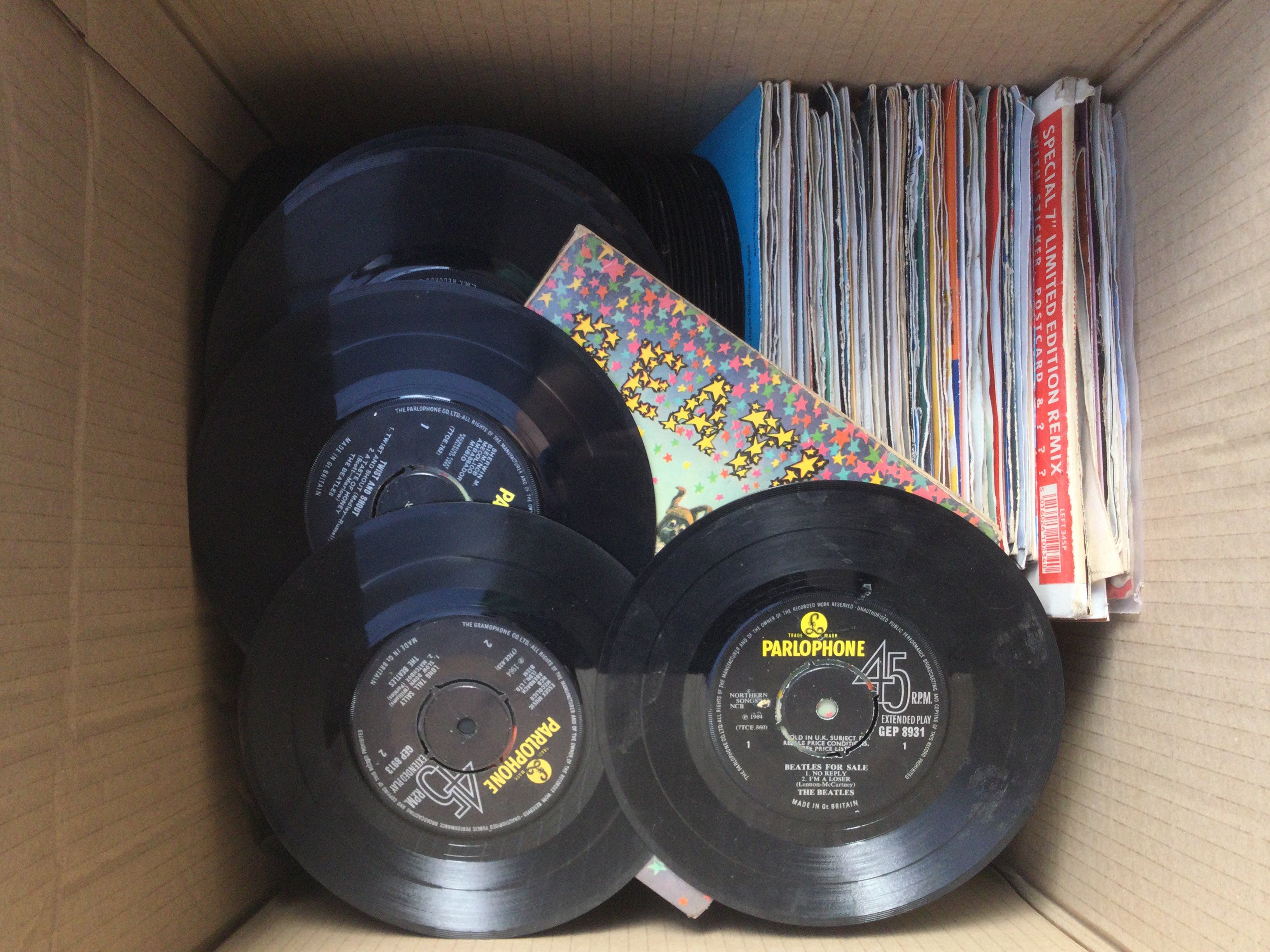 A box of 7" singles and EPs by various artists including The Beatles, Traffic, Deep Purple and many more.