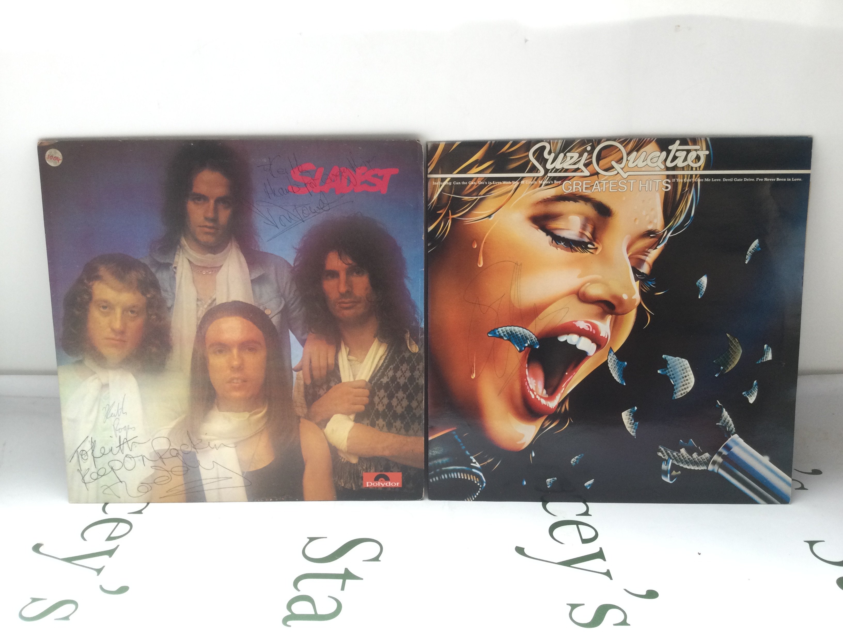 Two signed LPs comprising Sladest signed by Noddy Holder and Don Powell and a Greatest Hits compilation signed by Suzi Quattro.