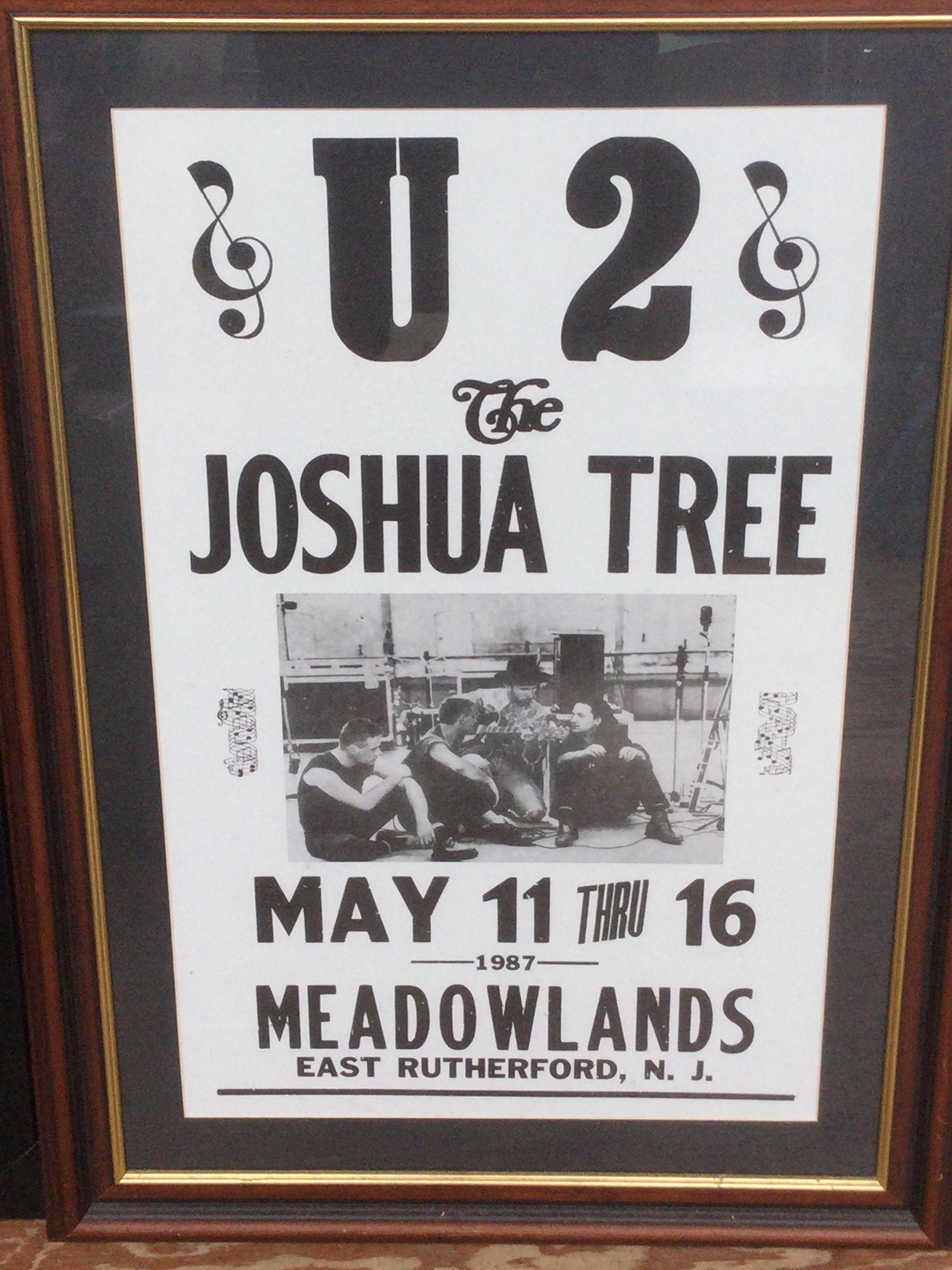 A framed and glazed reproduction U2 gig poster for a 1987 performance at Meadowlands, New Jersey. Approx 715cm x 51cm.