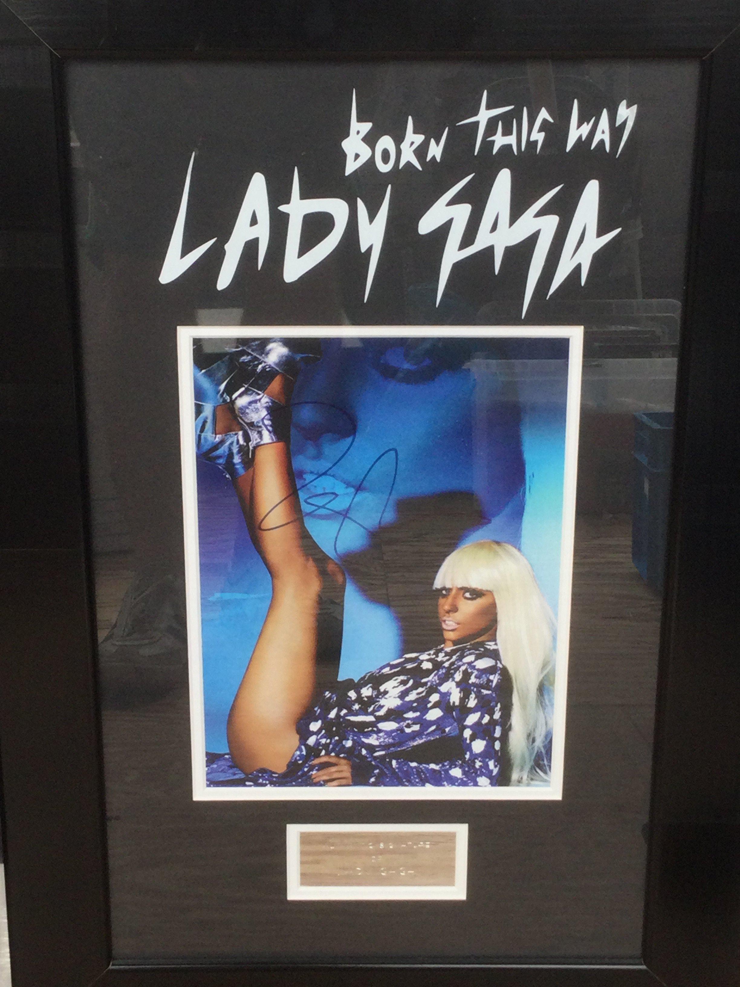 A framed and glazed signed Lady Gaga display with COA, approx 59.5cm x 40cm.