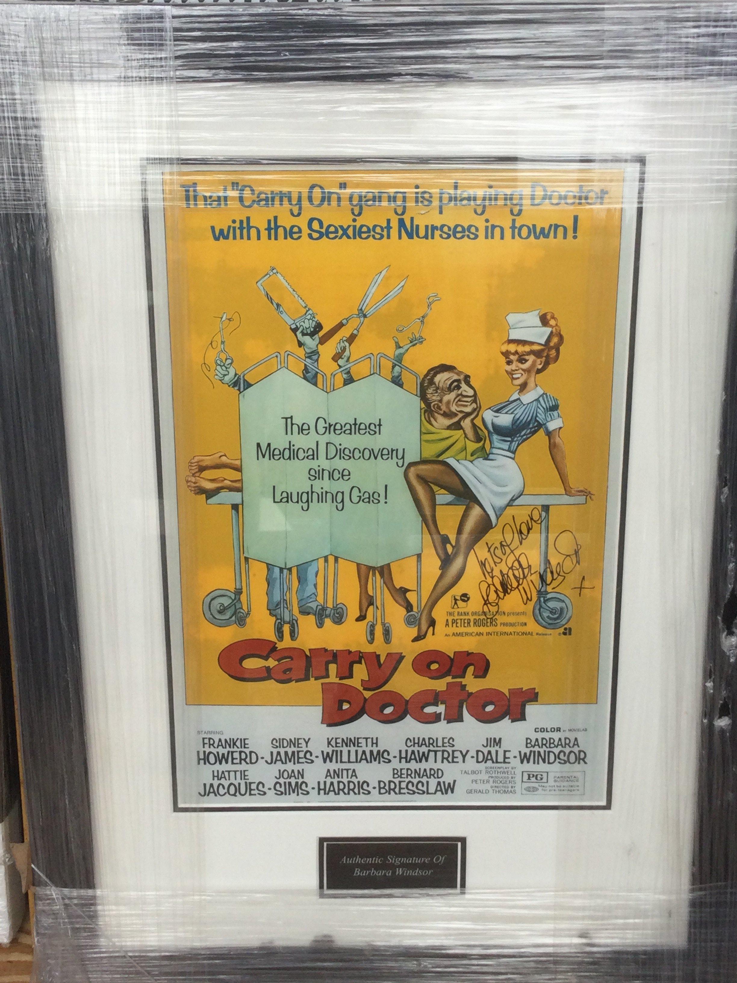 A framed and glazed Carry On Doctor mini poster signed by Barbara Windsor with COA, approx 63cm x 47cm.