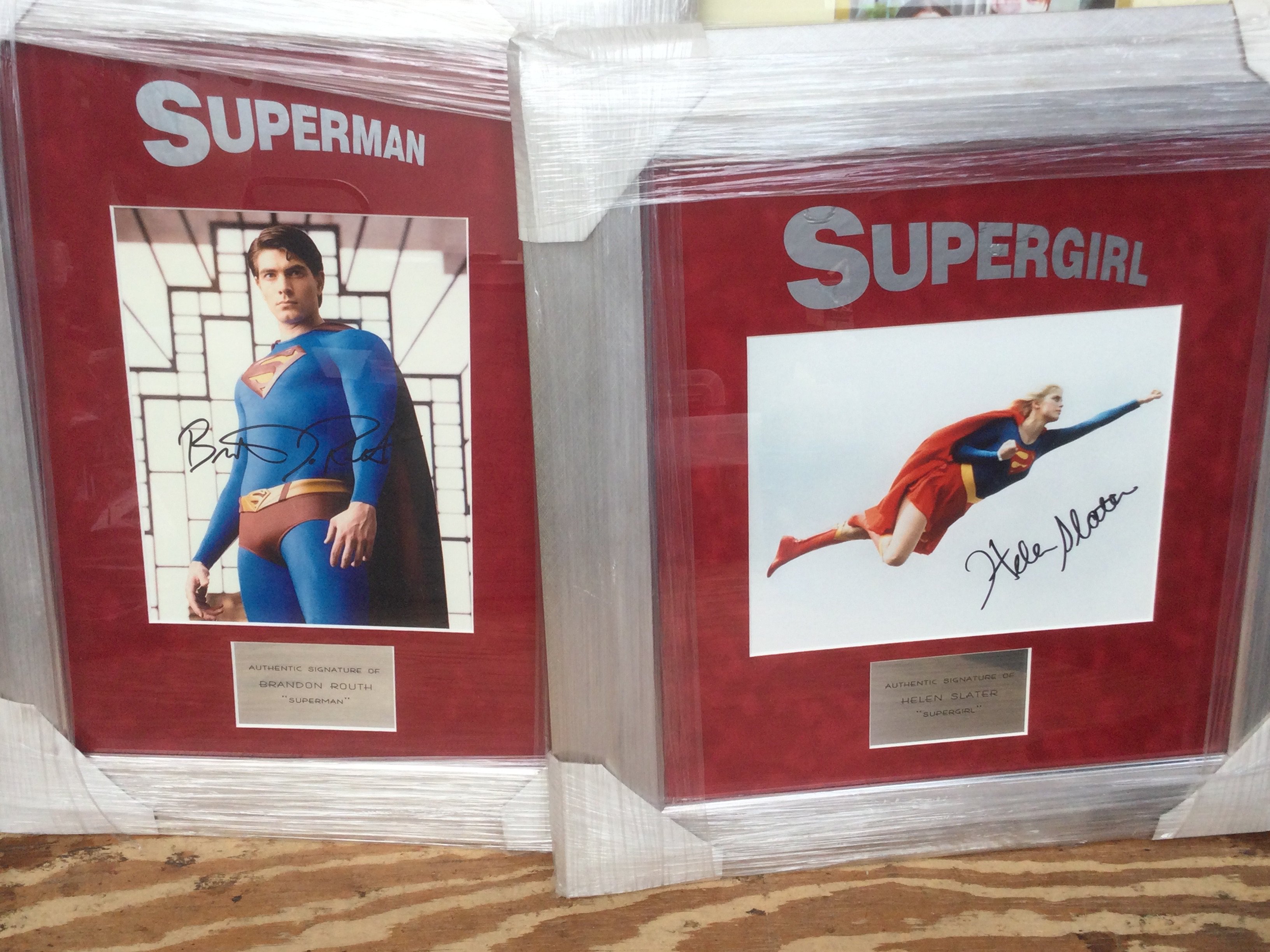 Two framed and glazed Superman and Supergirl displays signed by Brandon Routh and Helen Slater with COA for Superman, approx 55cm x 43cm and 51cm x 47cm.