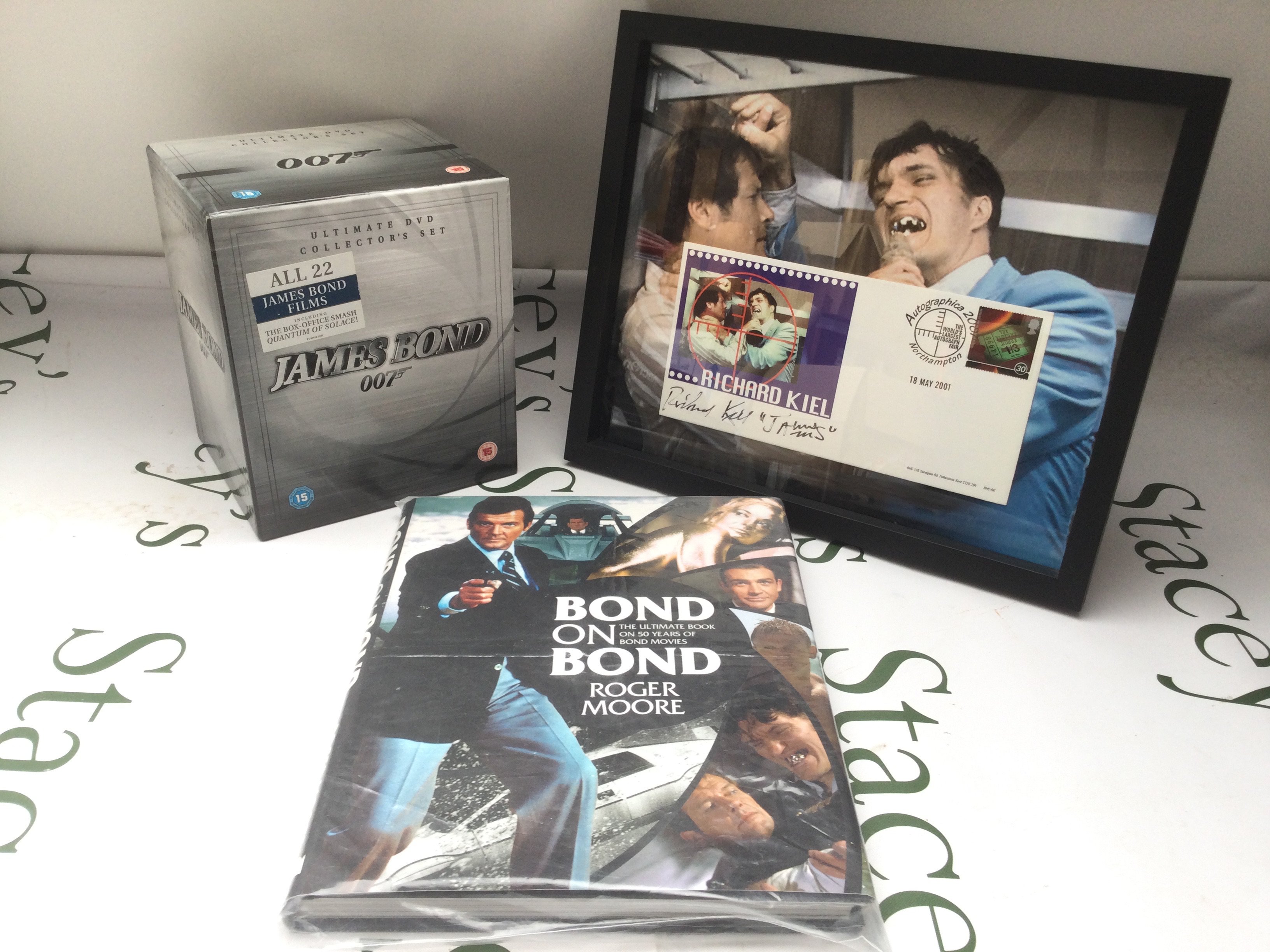A limited edition Bond On Bond book signed by Roger Moore together with a Richard Kiel signed 'Jaws' 007 ltd ed stamp cover and a James Bond 22DVD box set (3).