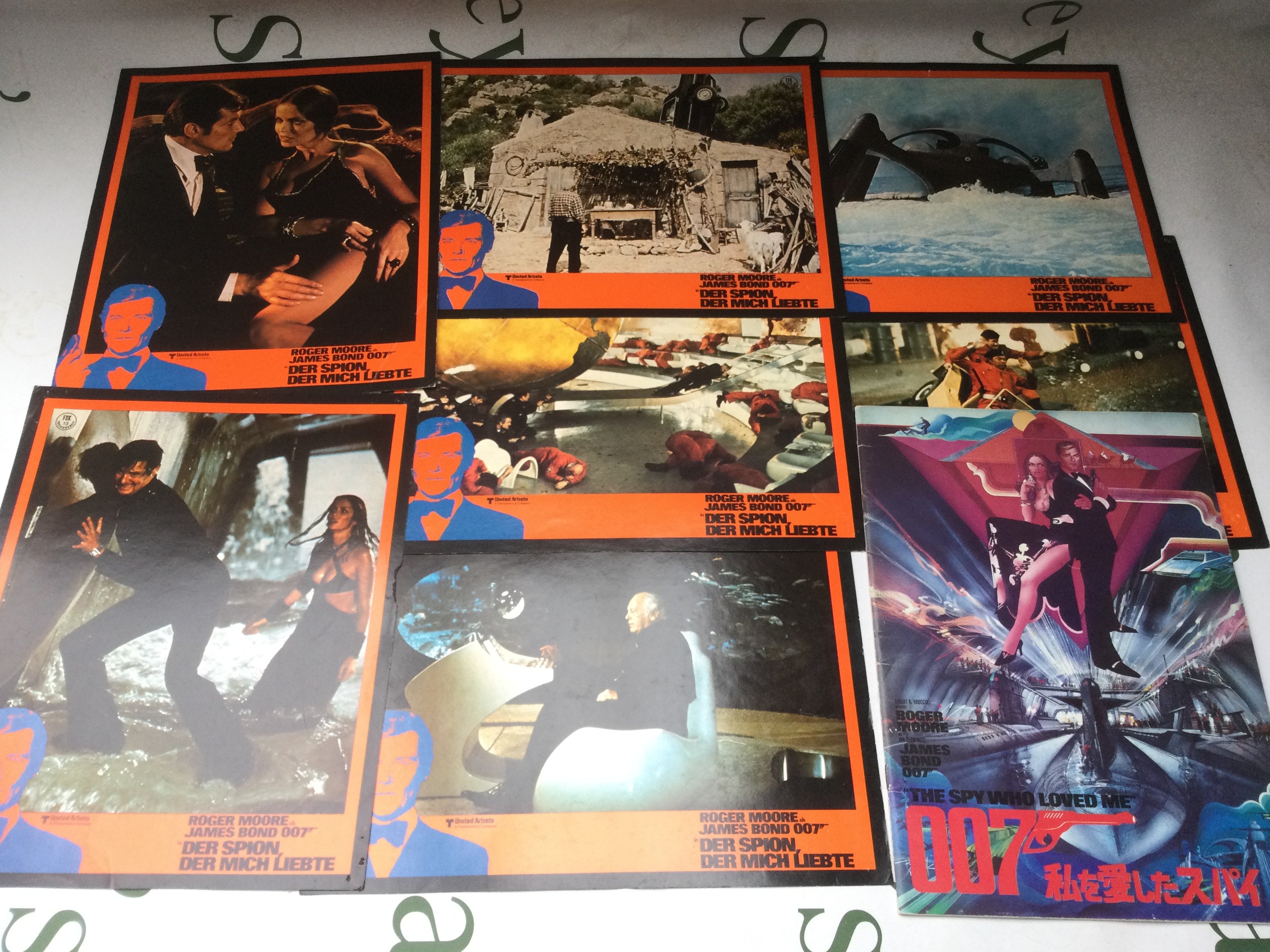 A collection of Roger Moore era James Bond lobby cards and film programs.