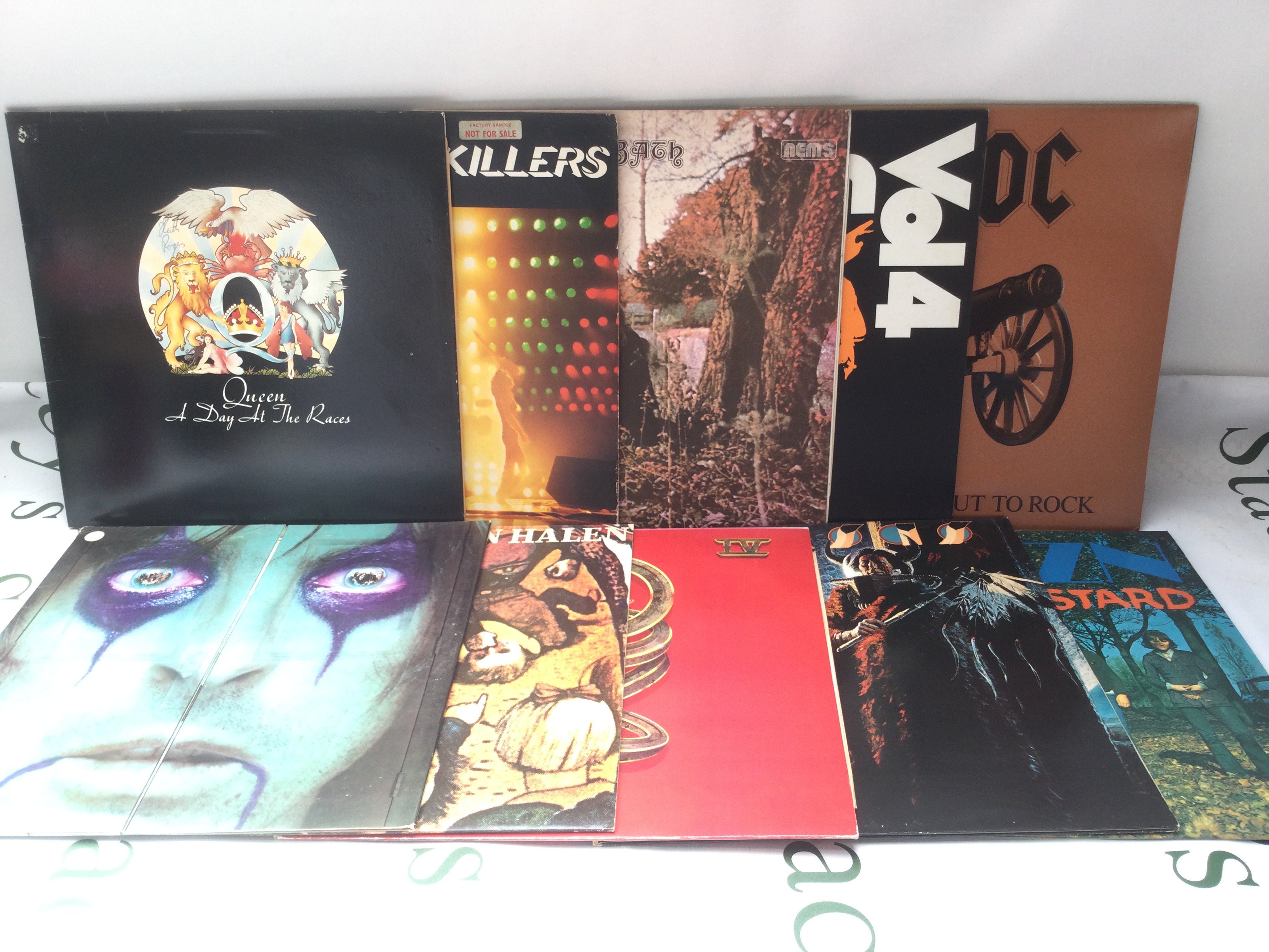 Ten rock and heavy rock LPs by various artists including Black Sabbath, Alice Cooper, Queen and others.