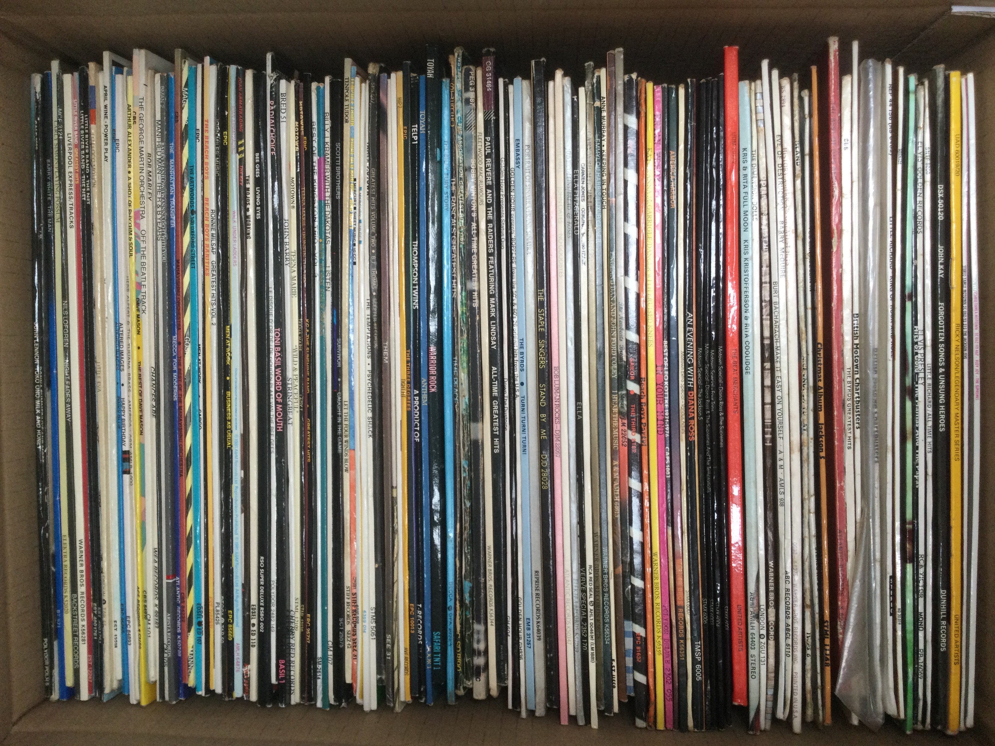 Two boxes of LPs by various artists including Elvis Presley, Bob Marley, Genesis and many more.