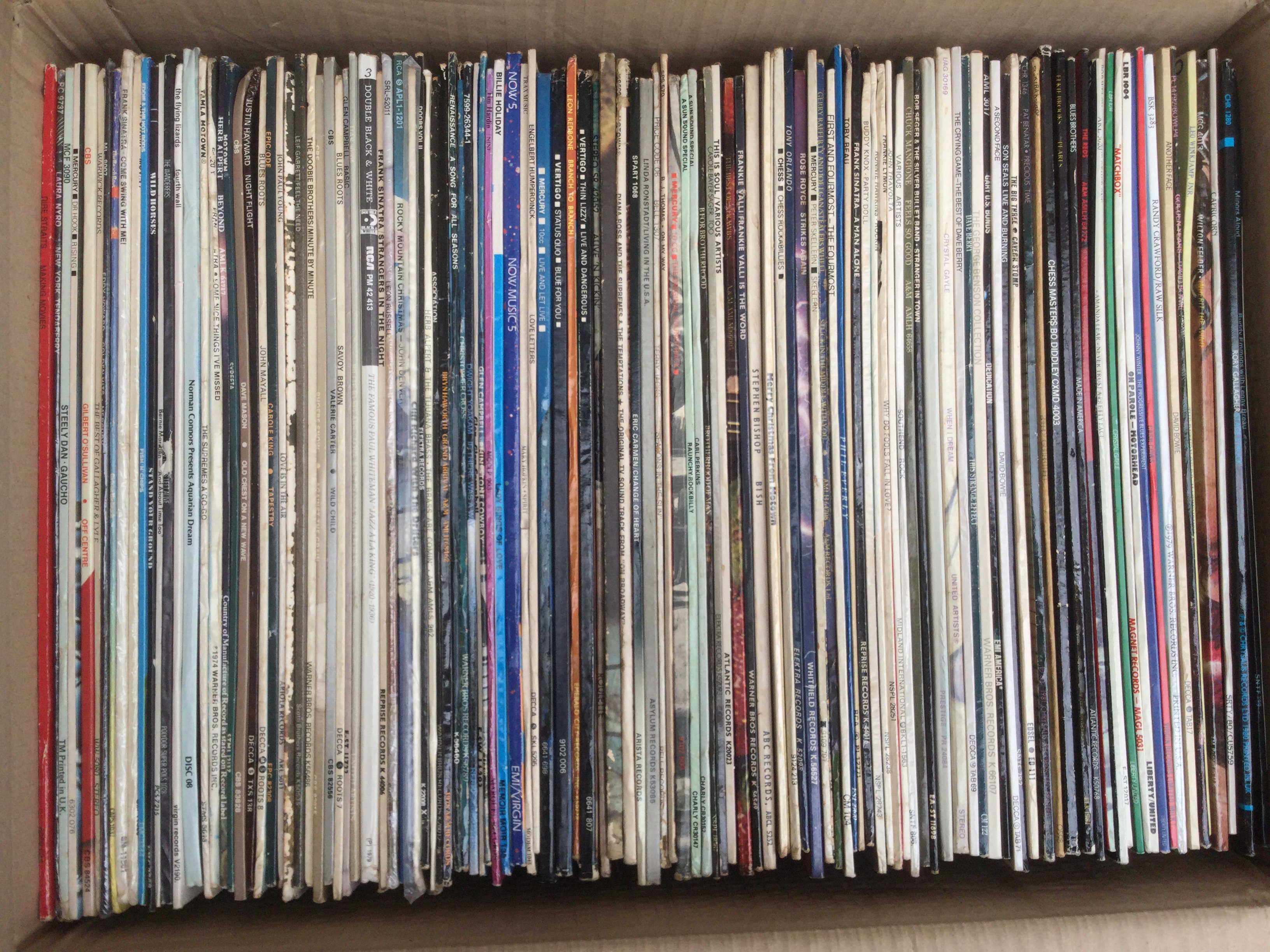 Two boxes of LPs and 12" singles by various artists including Rory Gallagher, Steely Dan, James Brown and many more.