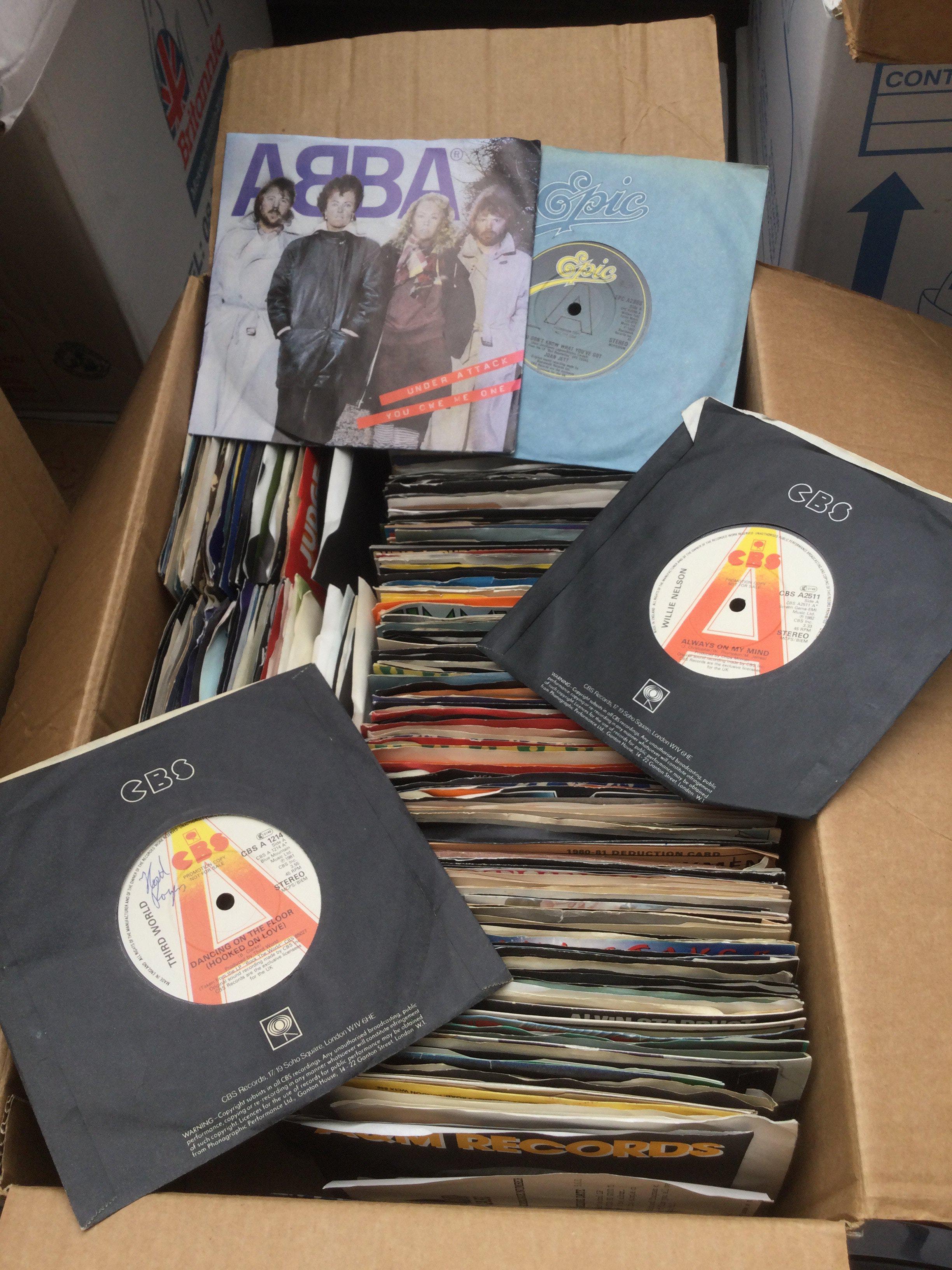 Two boxes of promo 7" singles by various artists including Abba, Michael Jackson, Queen and many more.