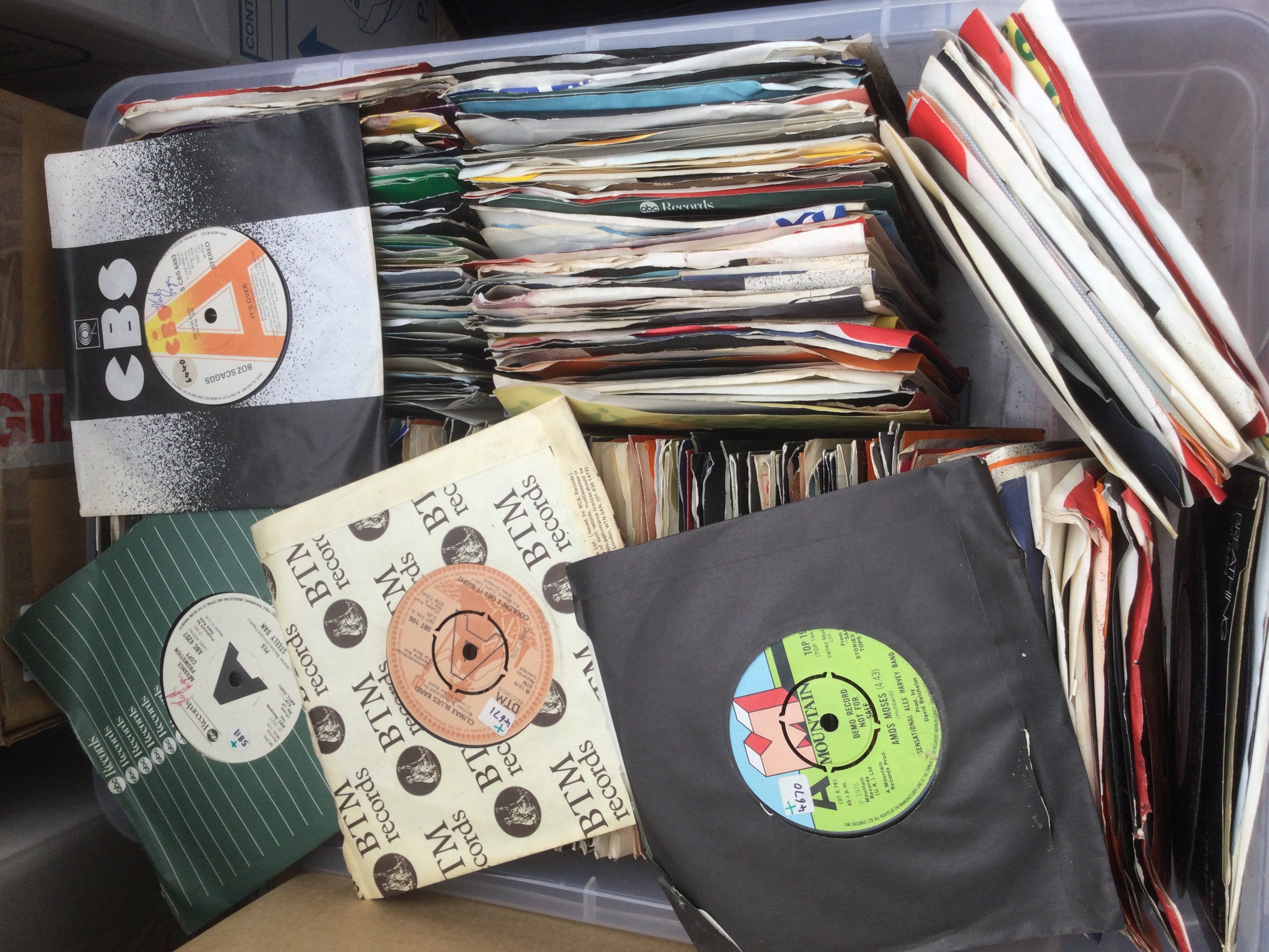 Two boxes of promo 7" singles by various artists including Judas Priest, Steely Dan, Kate Bush and many more.