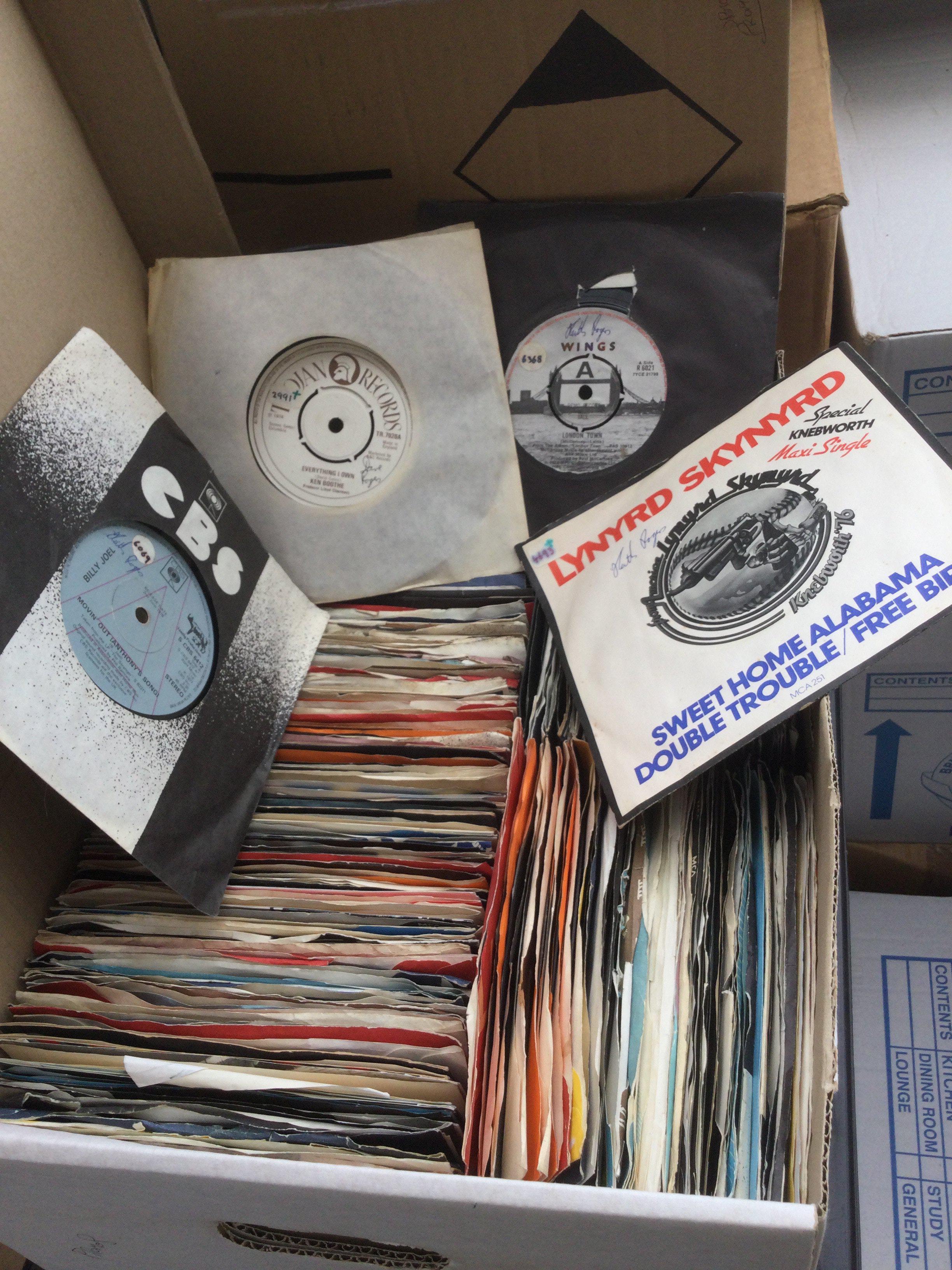 Two boxes of promo 7" singles by various artists including Wings, Billy Joel, The Beach Boys and many more plus some foreign Beatles singles and Elvis Presley EPs.