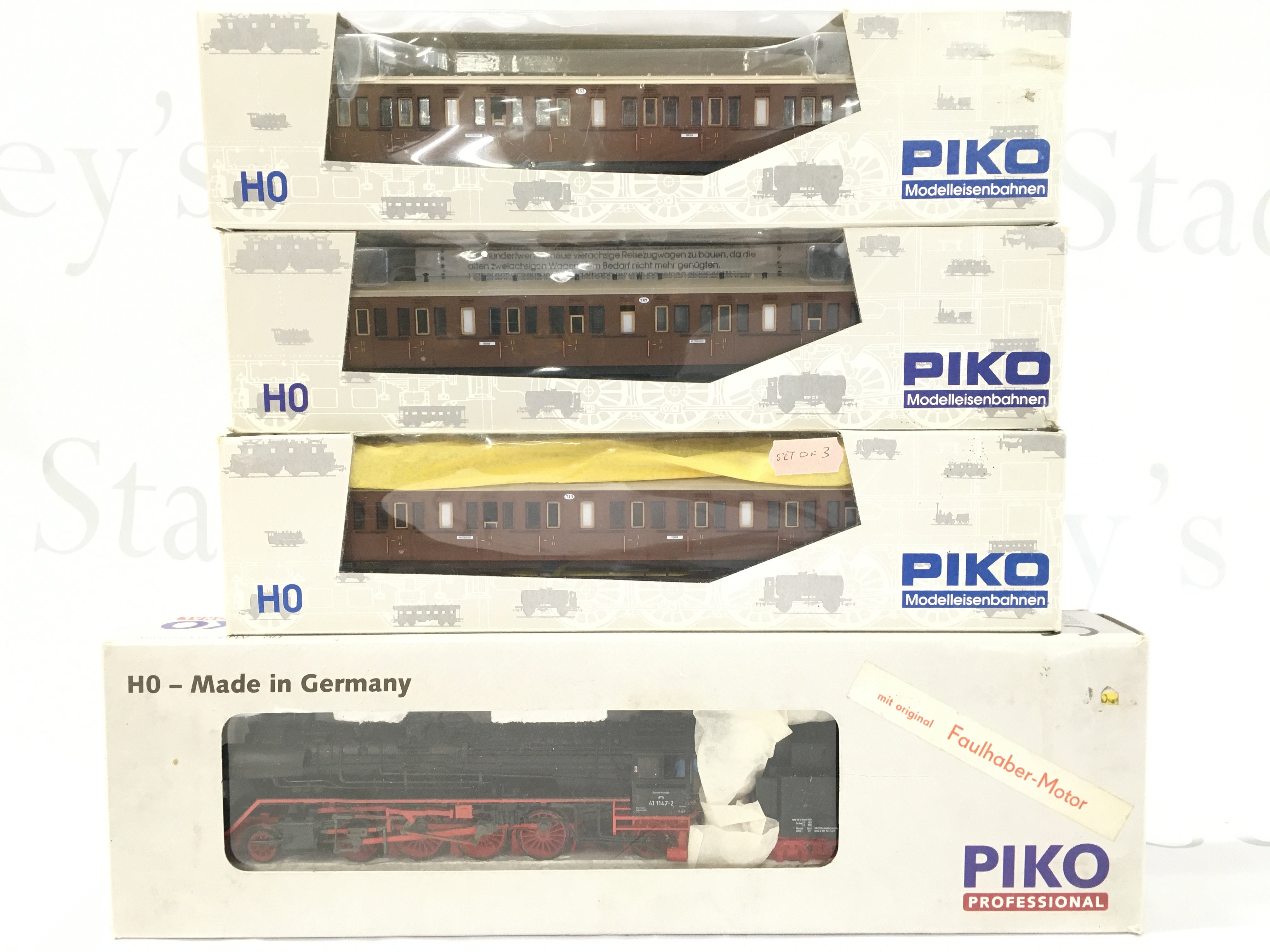 A Boxed H0 Gauge Piko Locomotive And 3 Boxed Coaches.