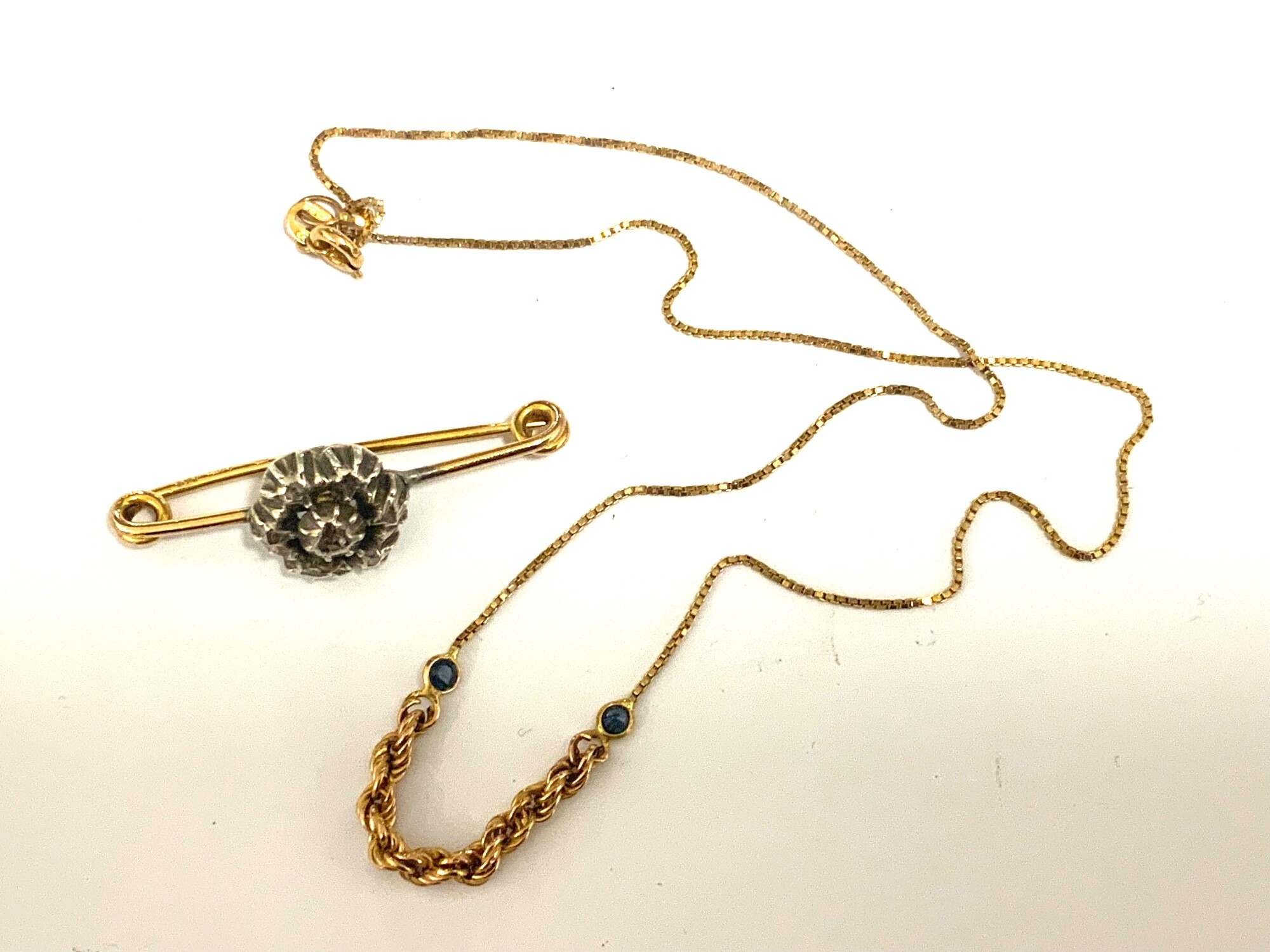 A 9ct part rope chain and stone set necklace together with a gold bar brooch.