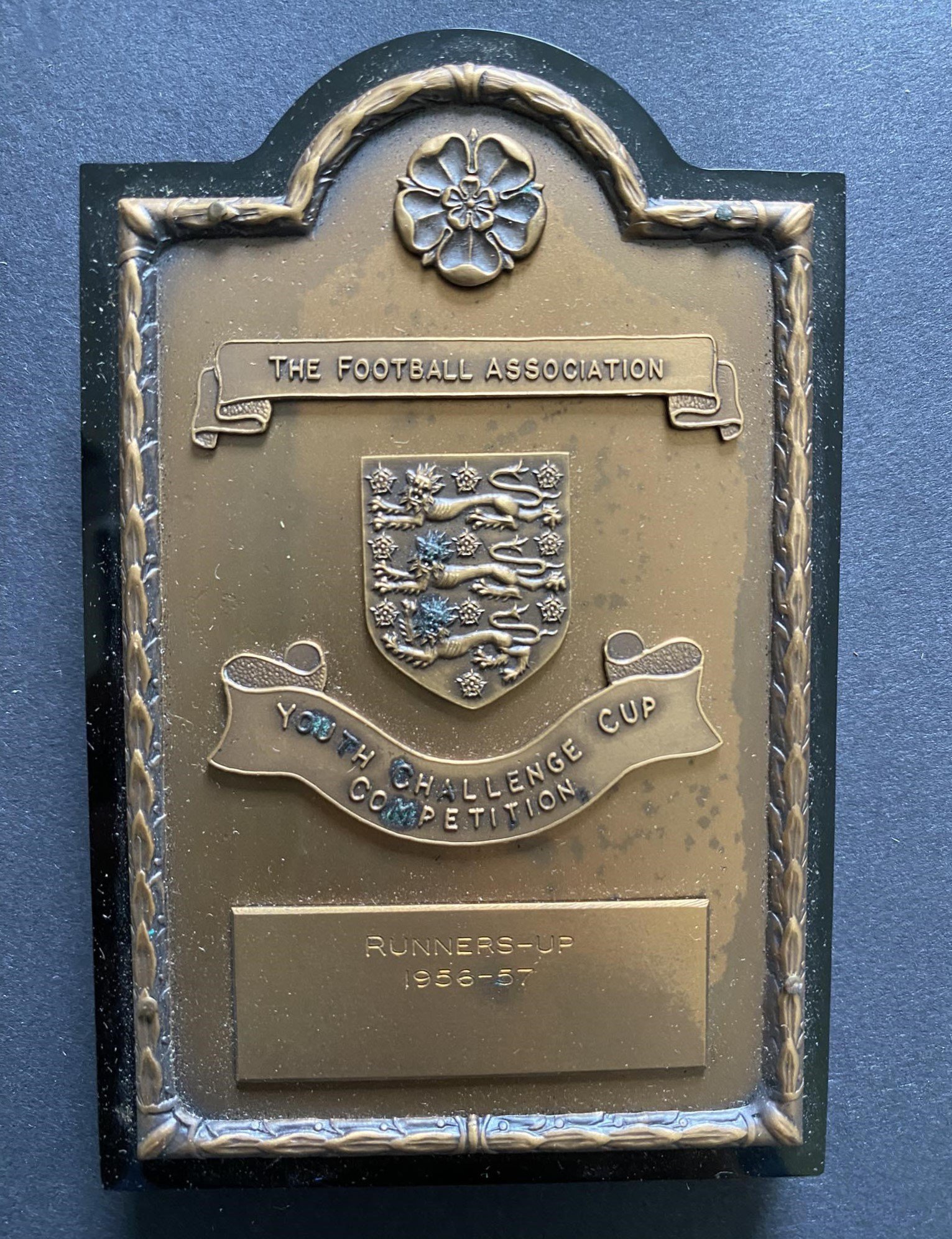 1957 John Lyalls West Ham Youth Cup Final Plaque: Attractive shield in original box engraved J Lyall. West Ham were runners up after losing the two legged final to Manchester United. Lyalls poor condition programme included.